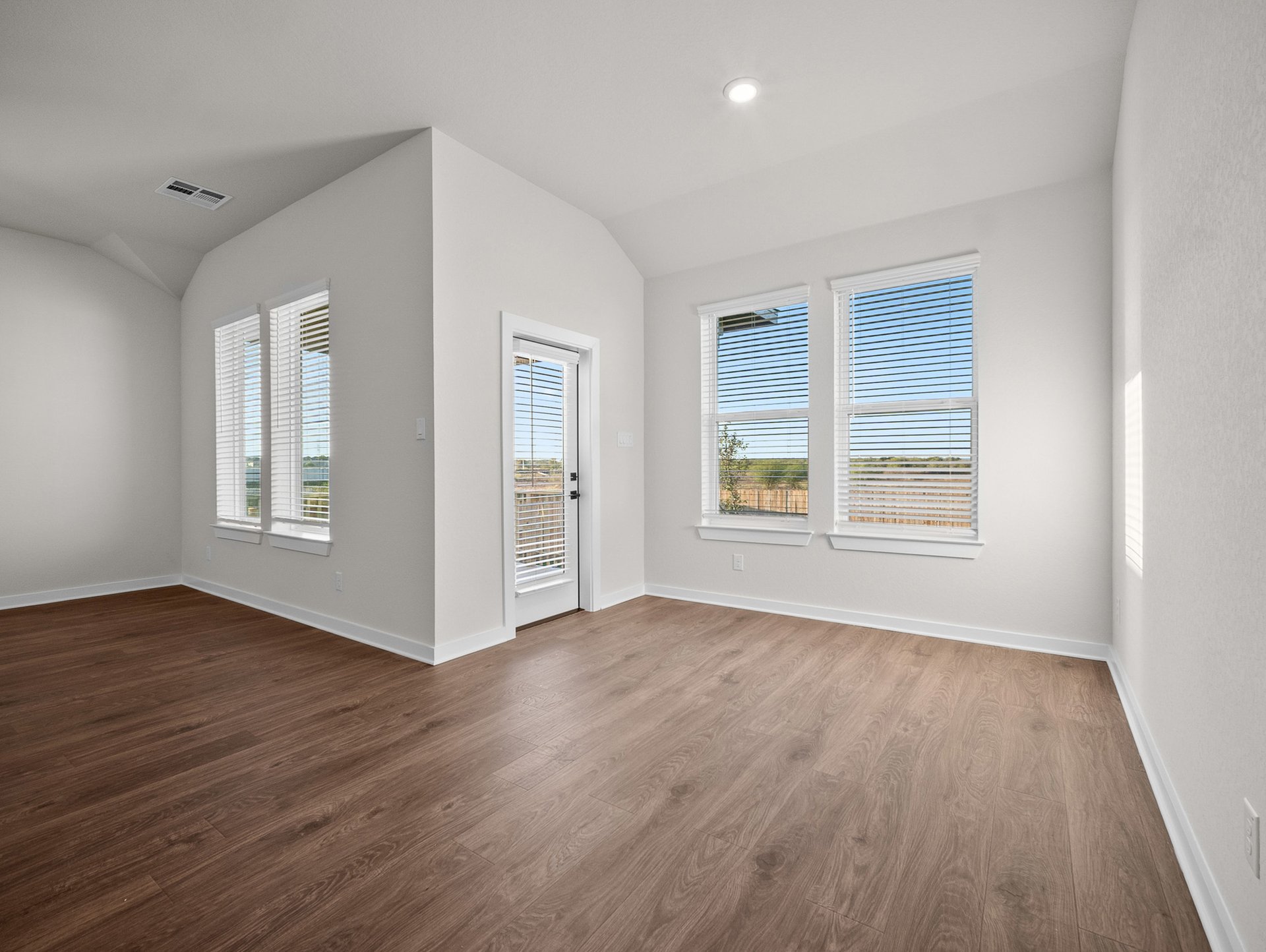 dining area with brown flooring, windows & recessed lighting