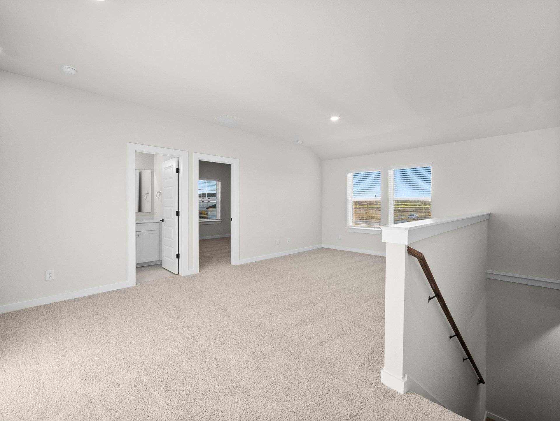 loft with carpet, windows & a sloped ceiling