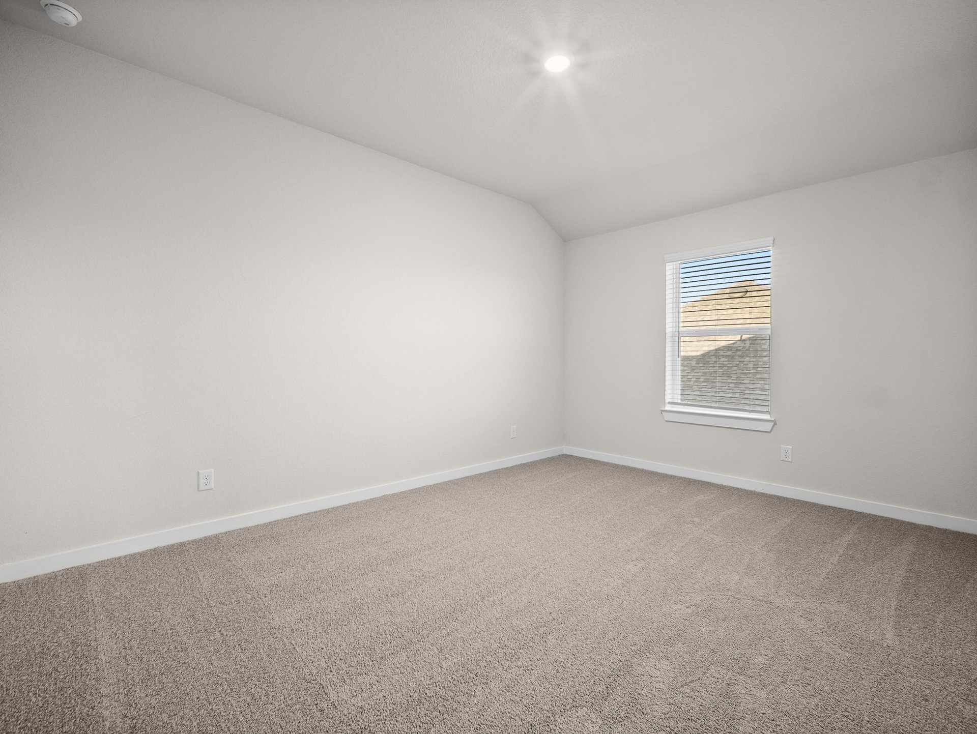 bedroom with carpet, a window & a sloped ceiling