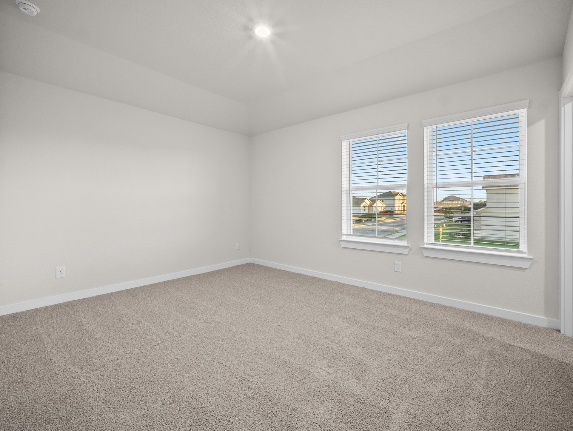 bedroom with carpet, windows & recessed lighting