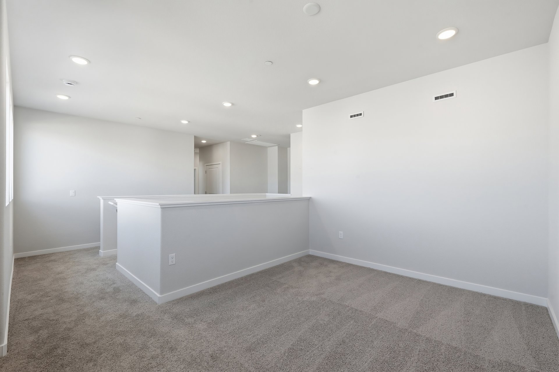 loft with gray carpet, white walls, and recessed ceiling lights