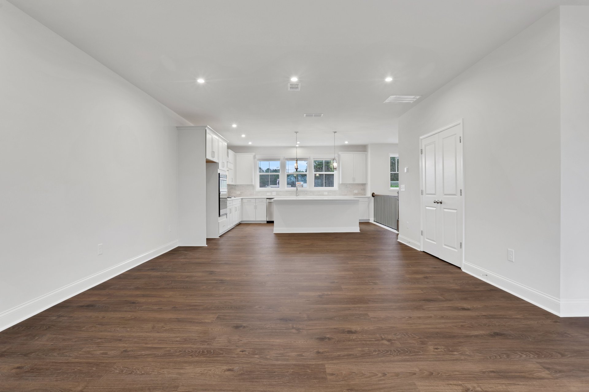 dining room with hard surface flooring connected to kitchen and great room