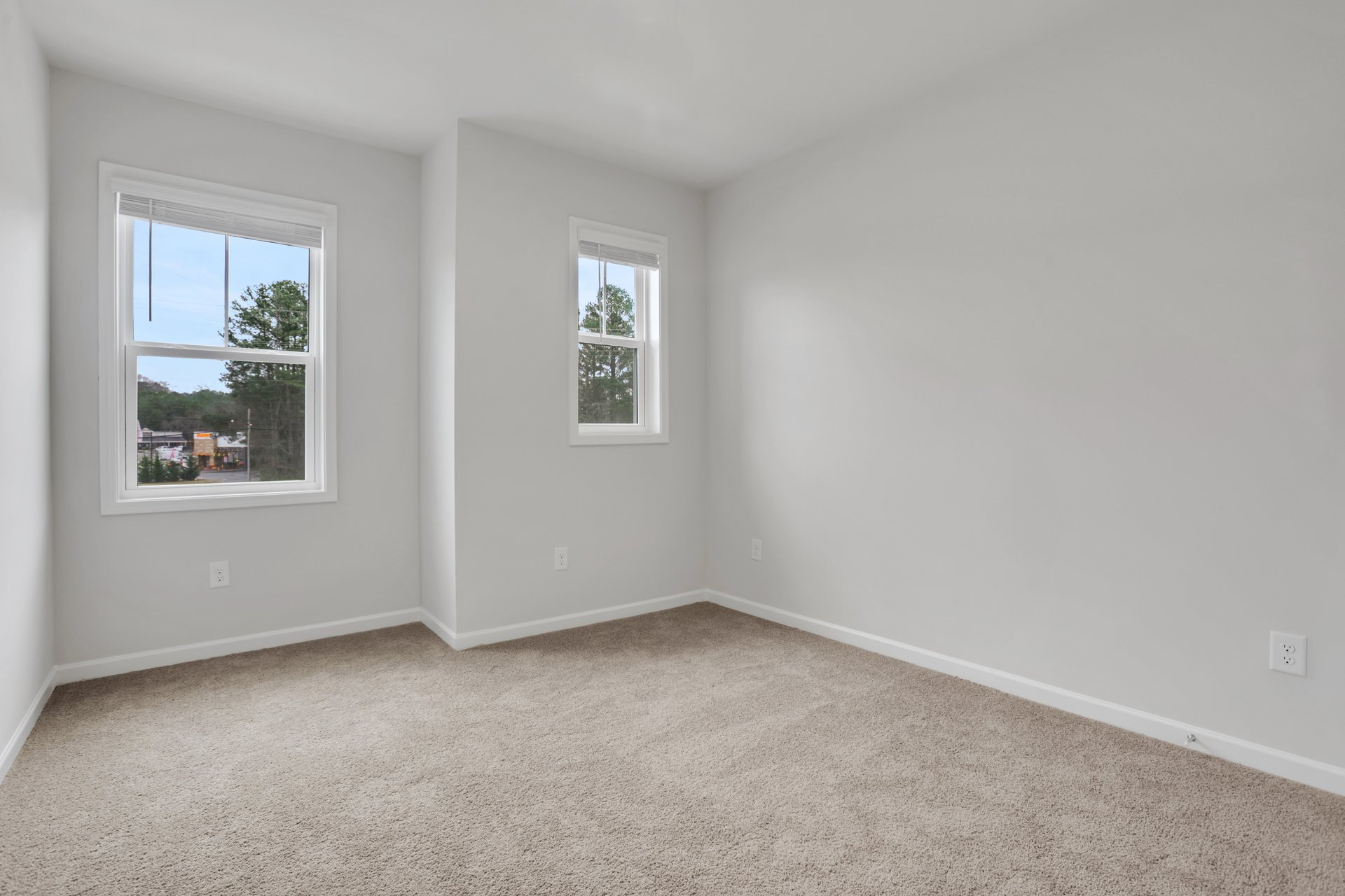 bedroom with windows and carpets