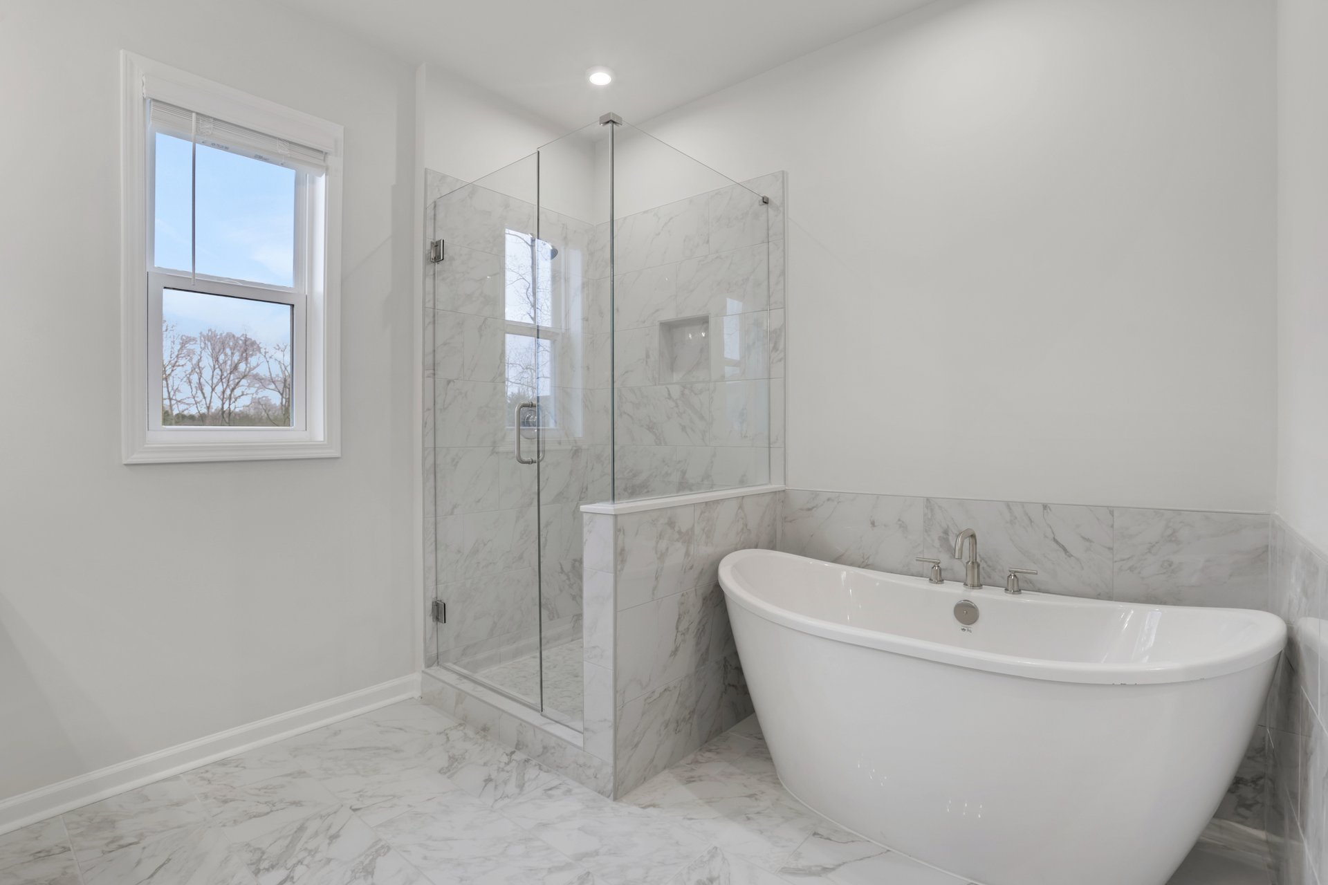 primary bathroom with separate shower and standalone tub