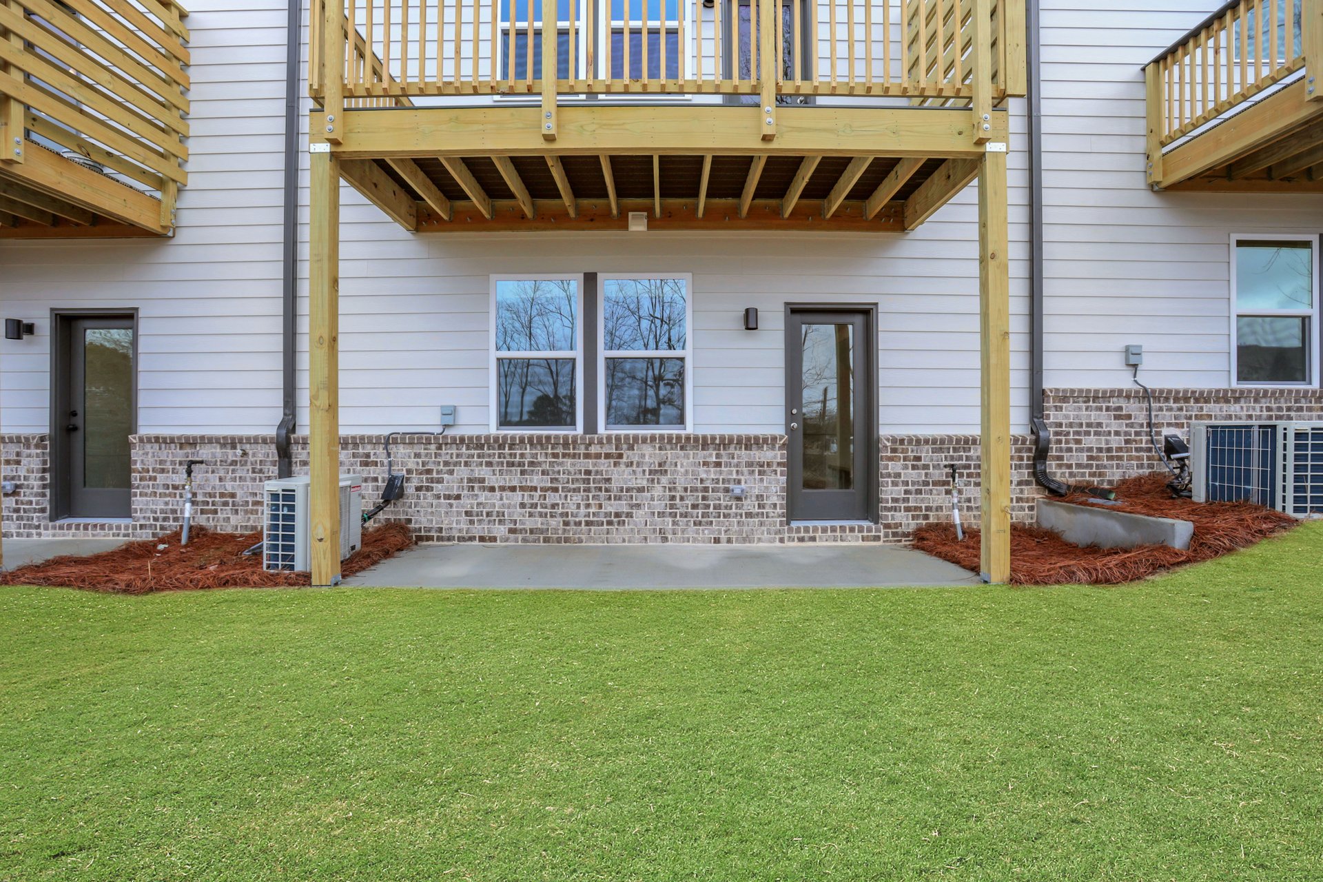 backyard of townhome with grass and deck