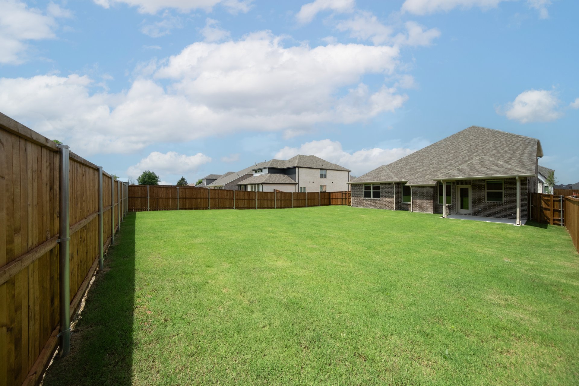 backyard with grass and covered patio