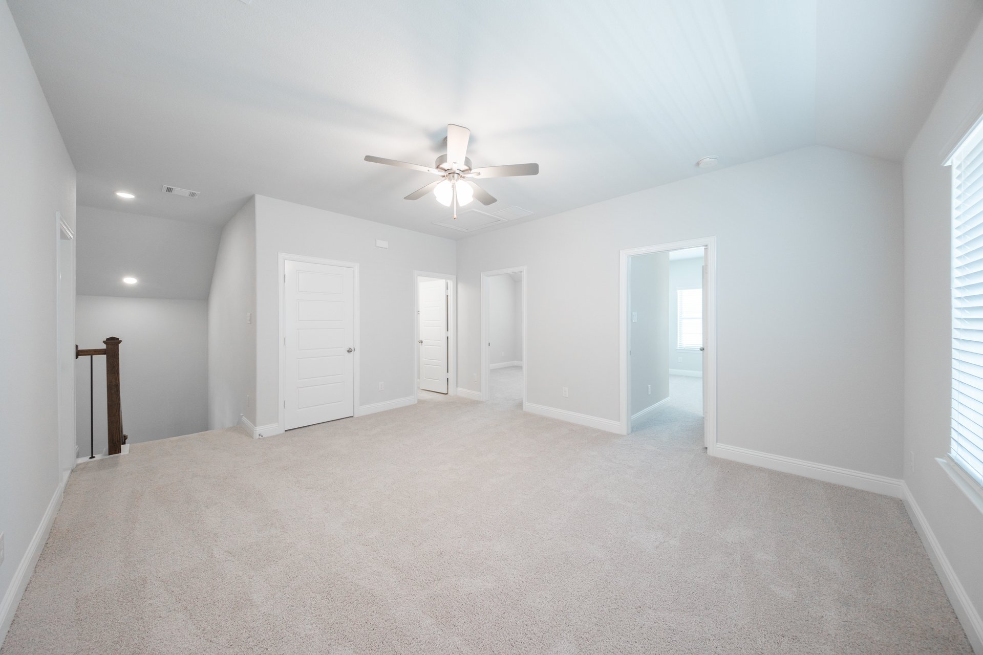 open gameroom with carpet and ceiling fan