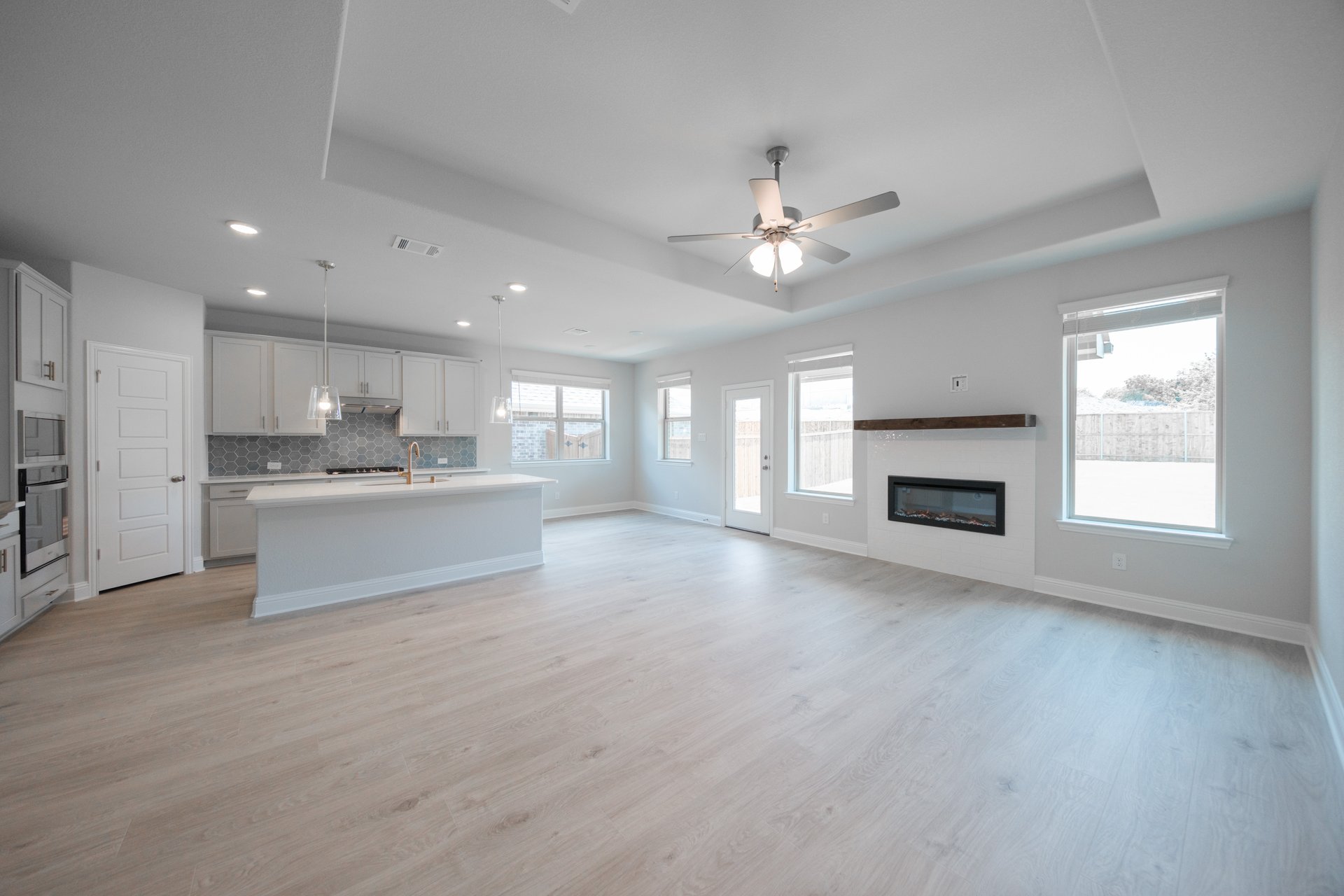 open great room with wood floors and fireplace