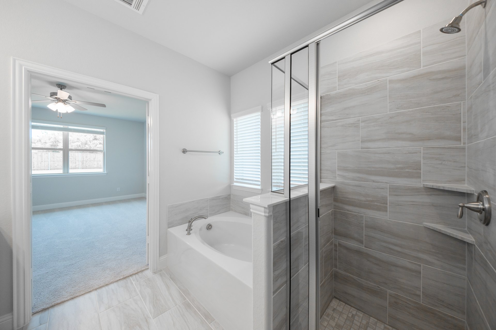 primary bathroom with soaking tub and walk-in shower