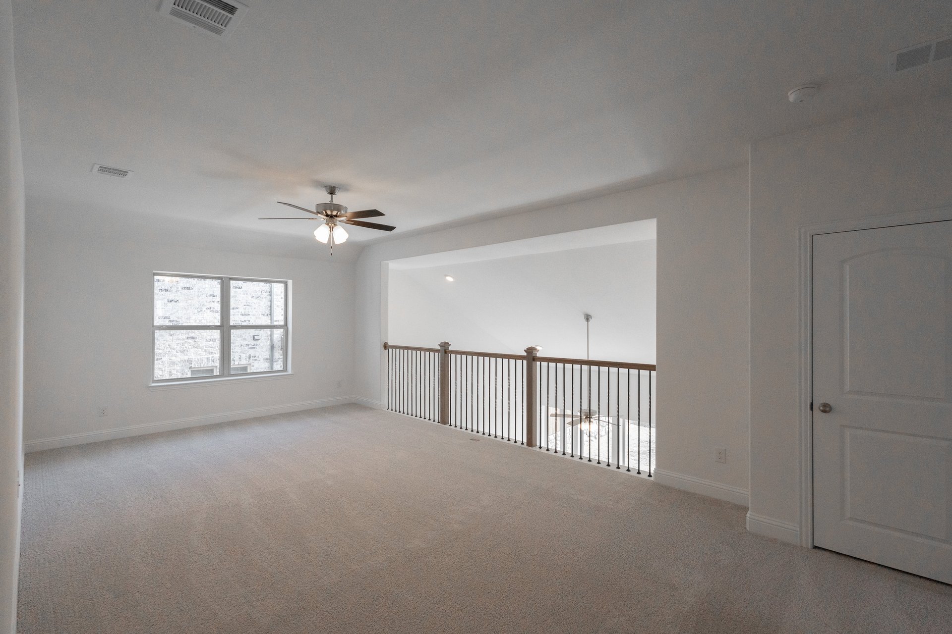 spacious loft with ceiling fan