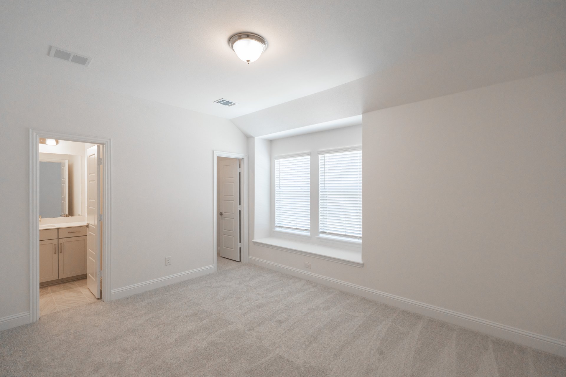 room with carpet and large windows with window seat
