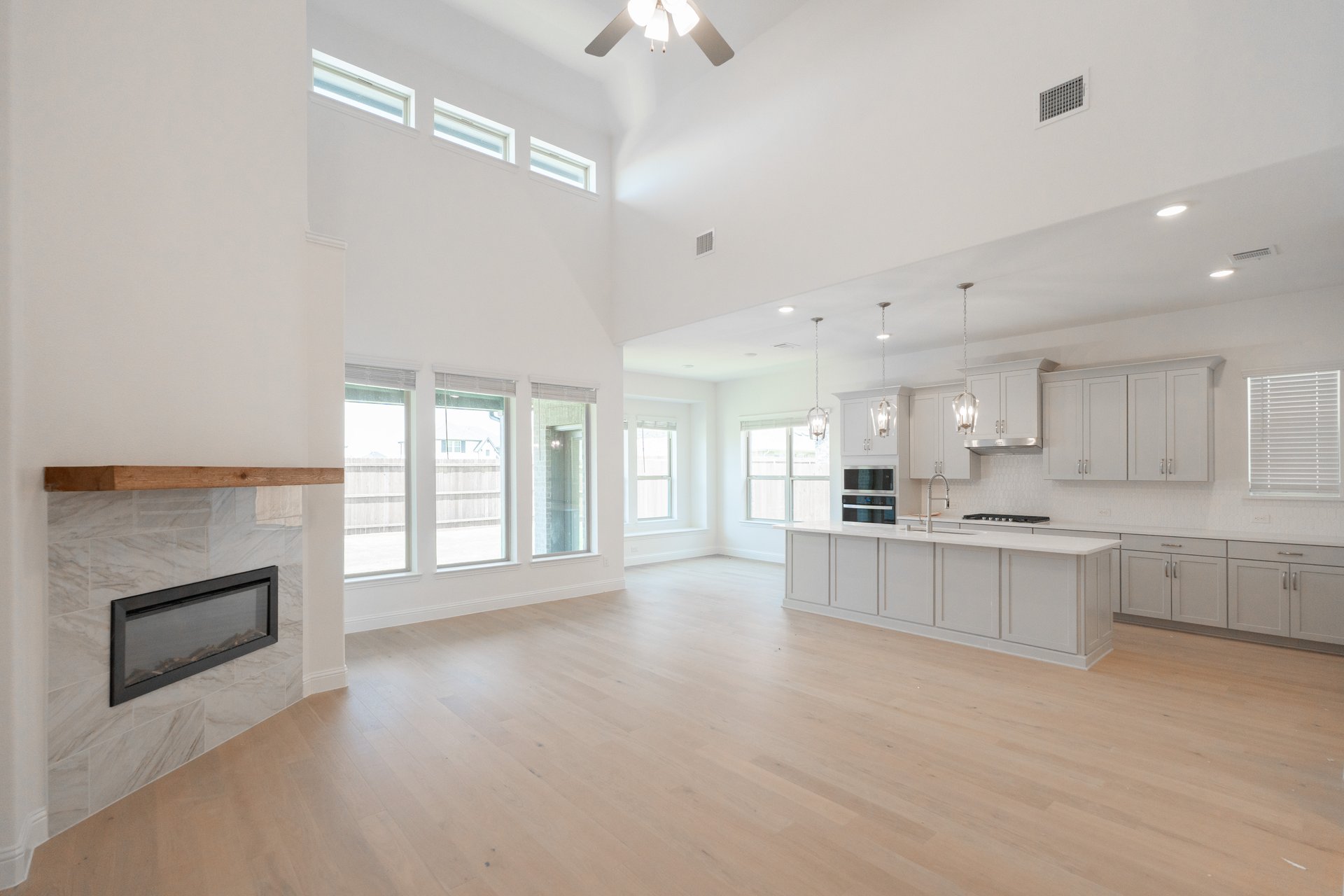 great room with wood flooring and fireplace