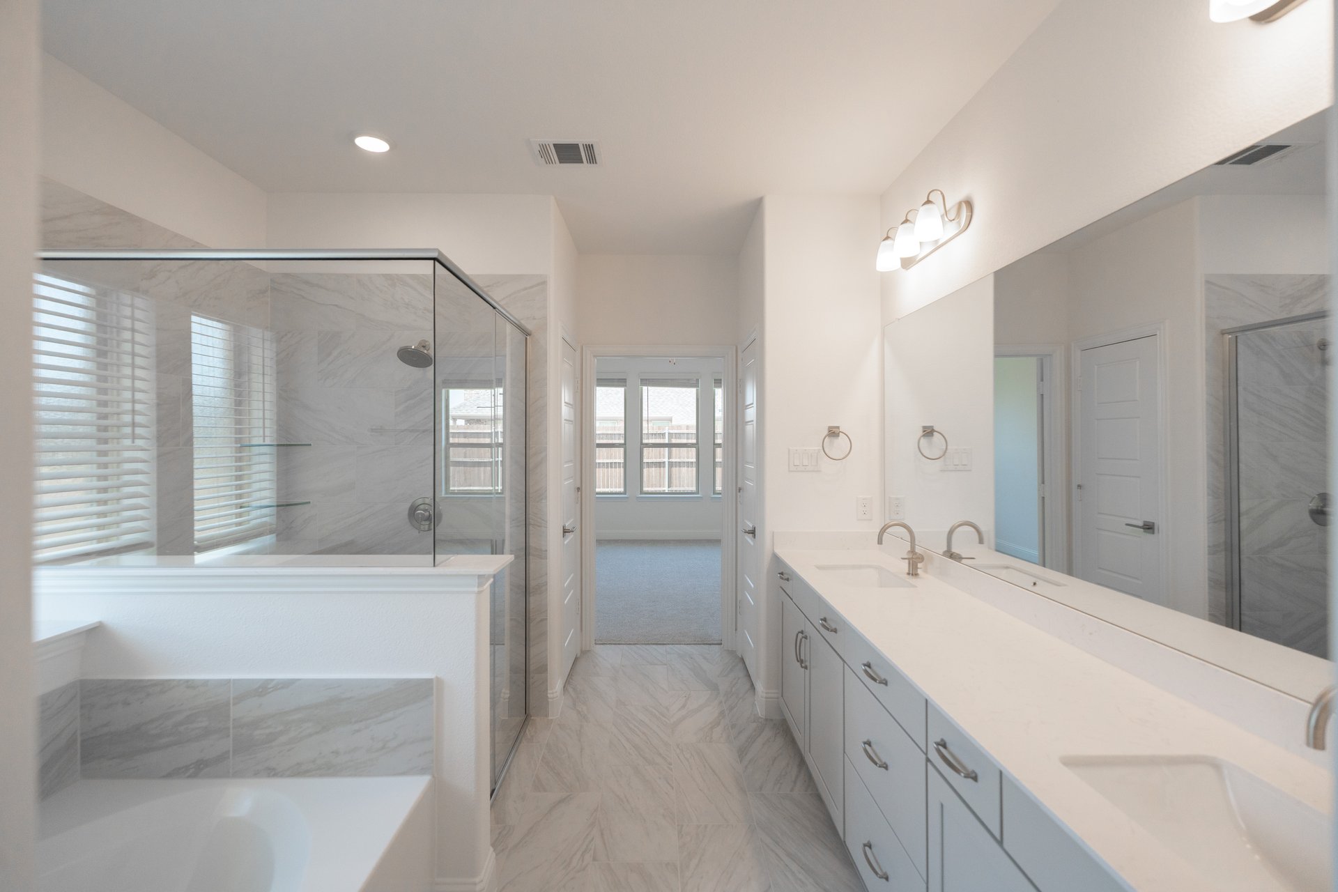 bathroom with white countertops, walk-in shower, and tub
