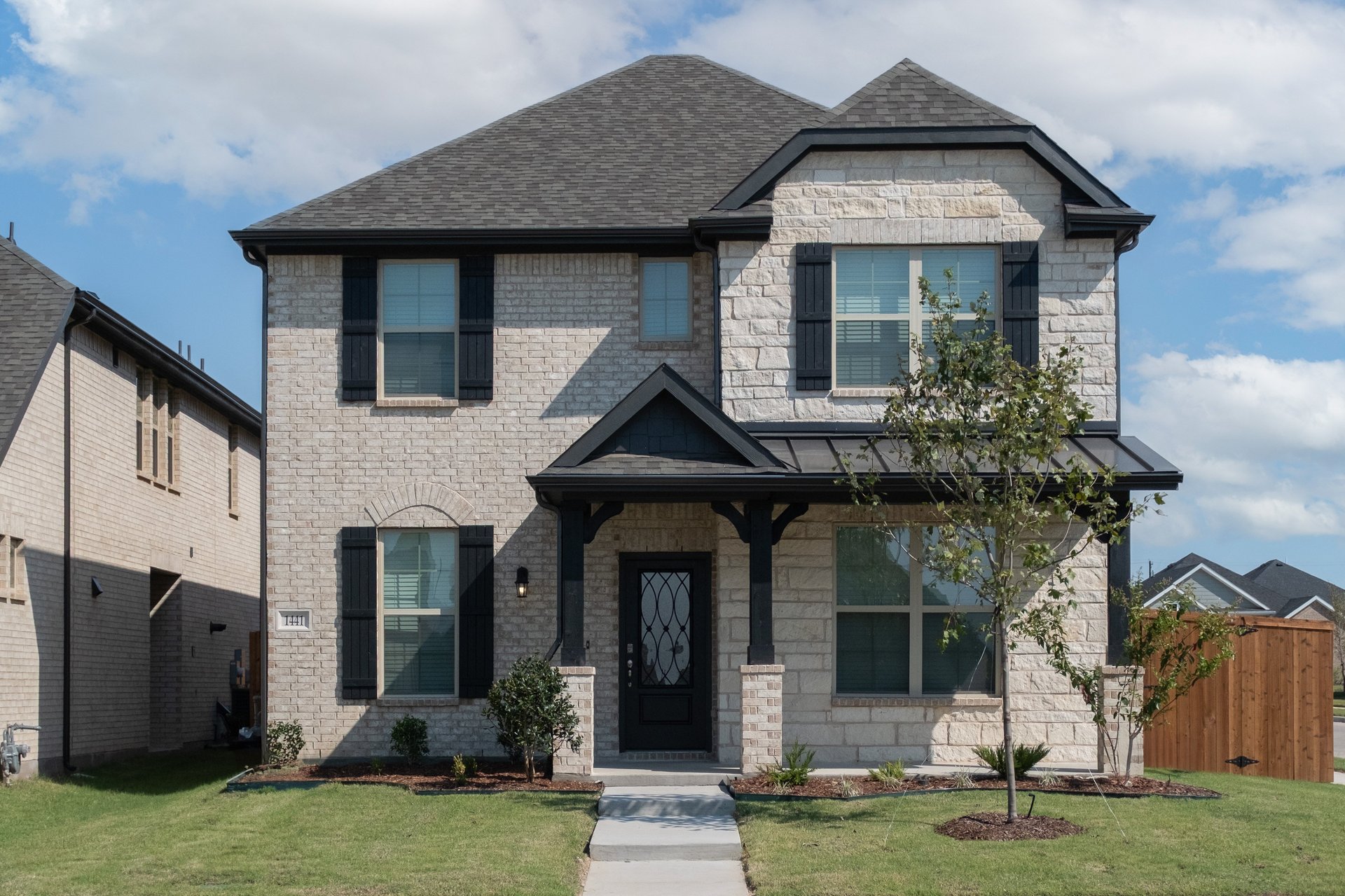 exterior of home with white brick and white stone