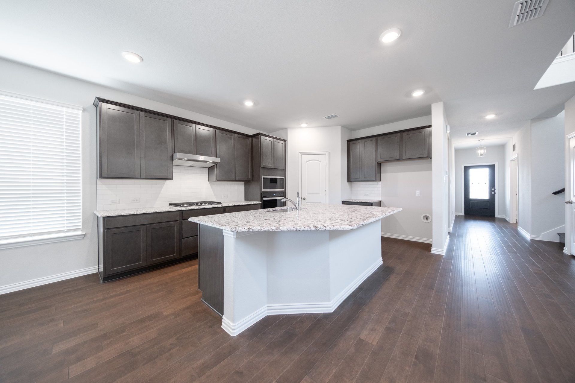 open kitchen with white granite countertops