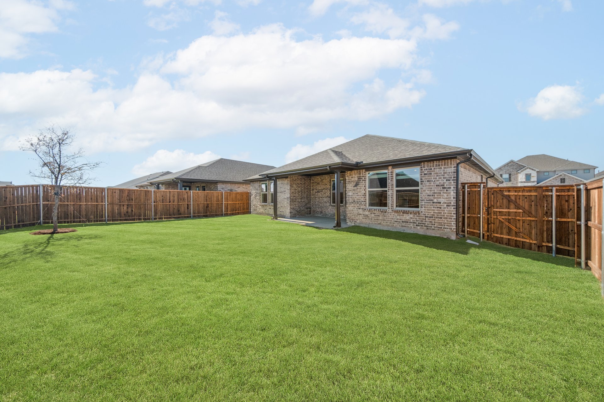 backyard with grass and covered patio