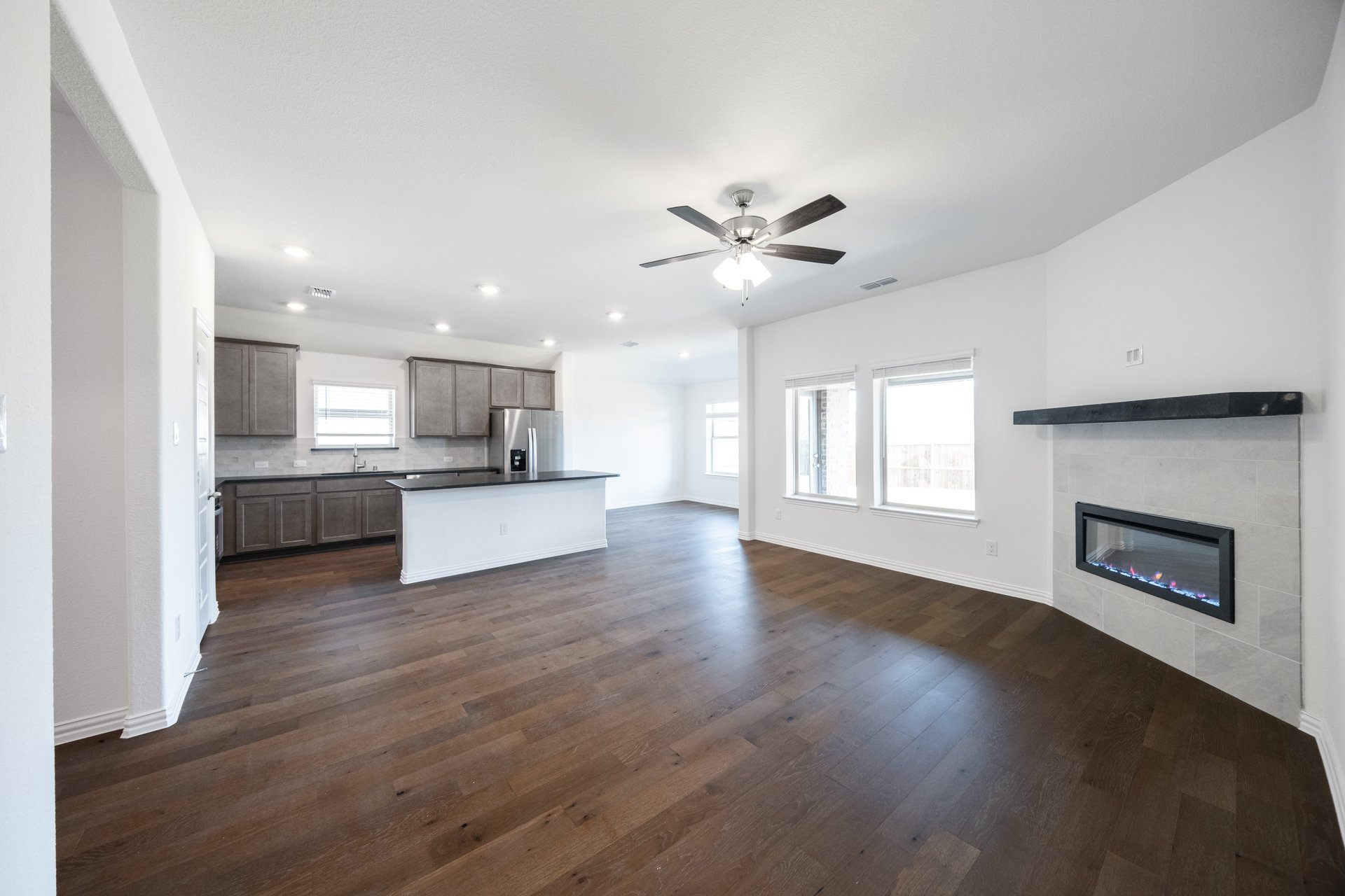 great room with wood floors and fireplace