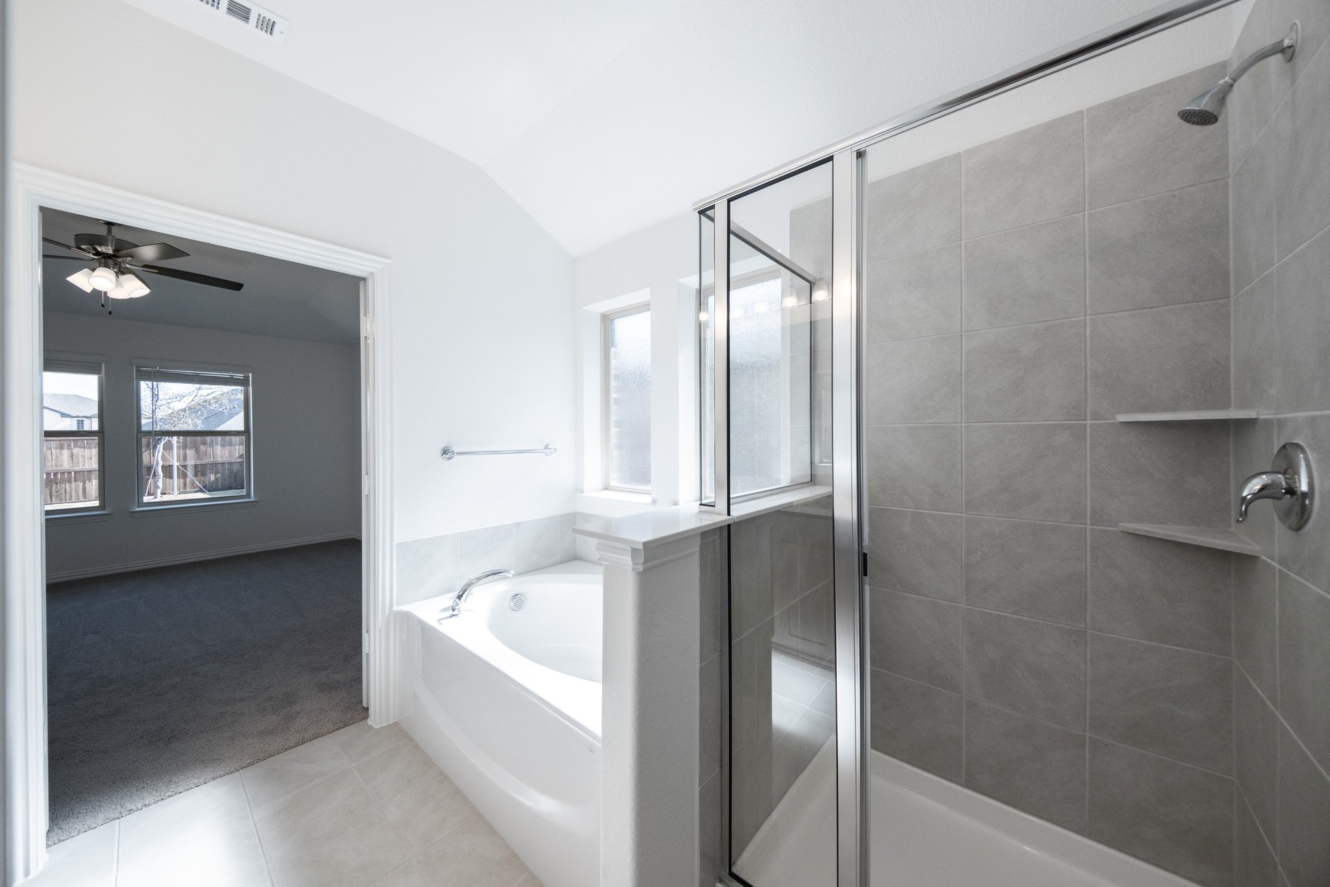 bathroom with large soaking tub and walk-in shower