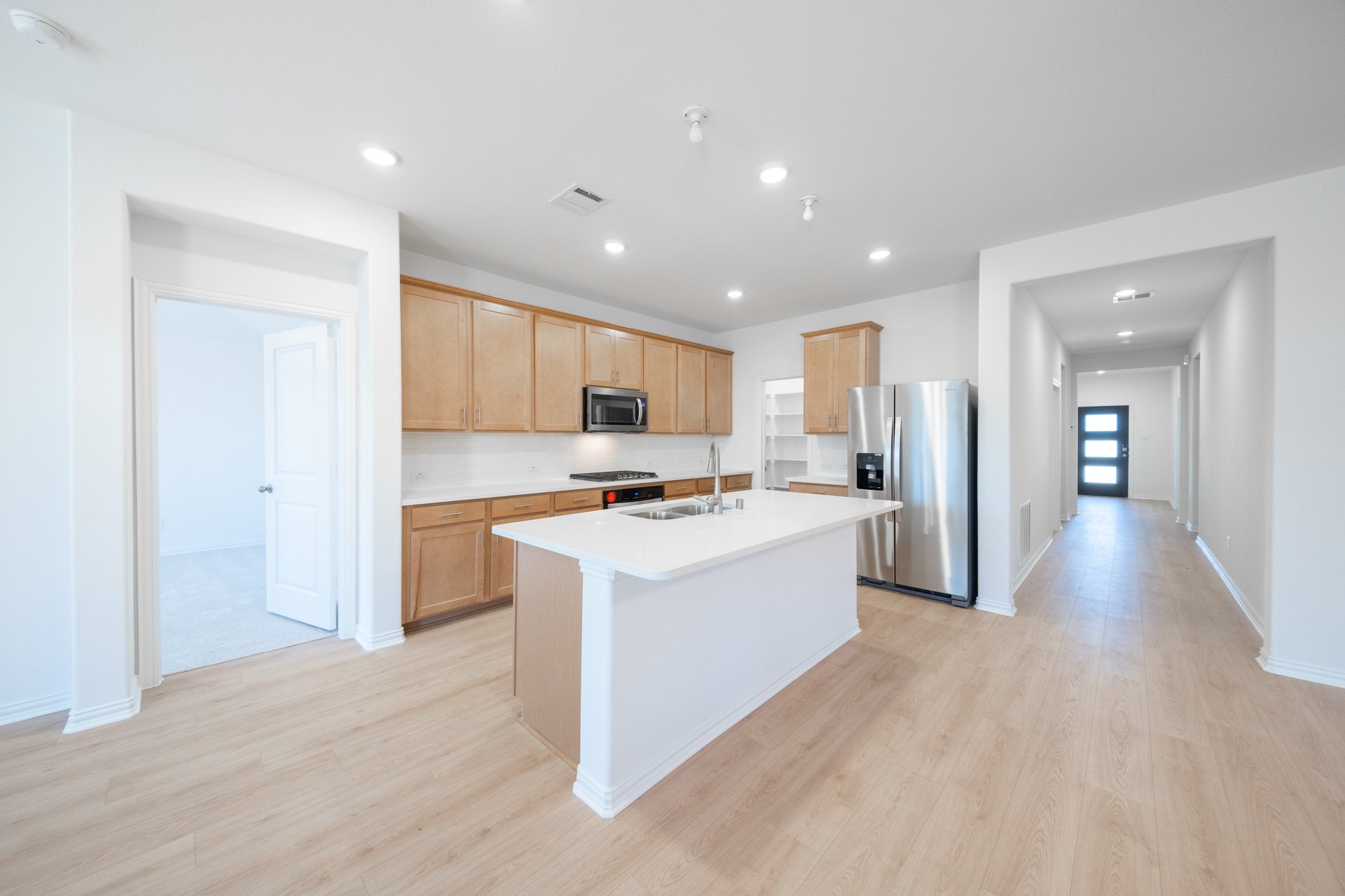 open kitchen with wood cabinets