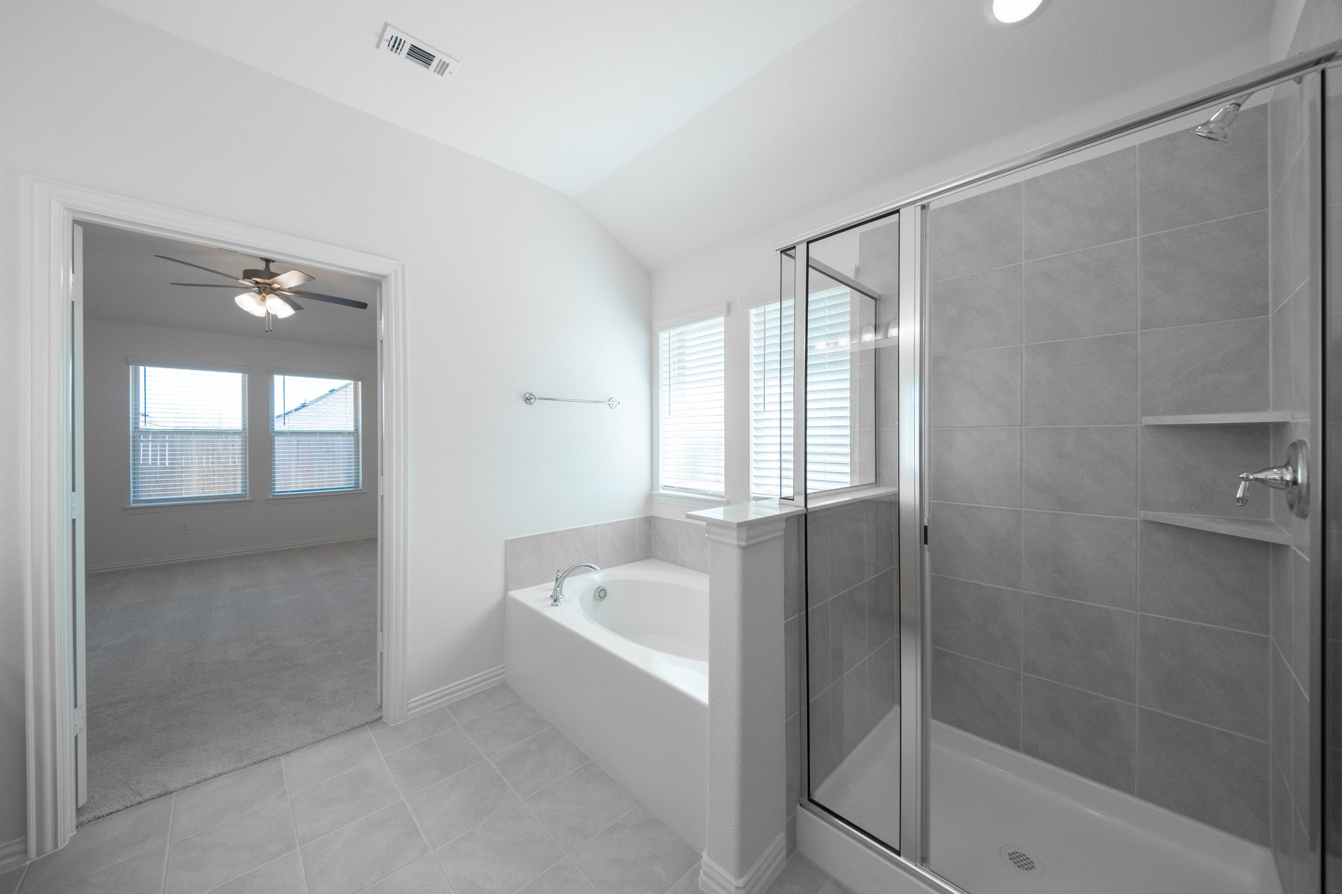 primary bathroom with walk-in shower and soaking tub