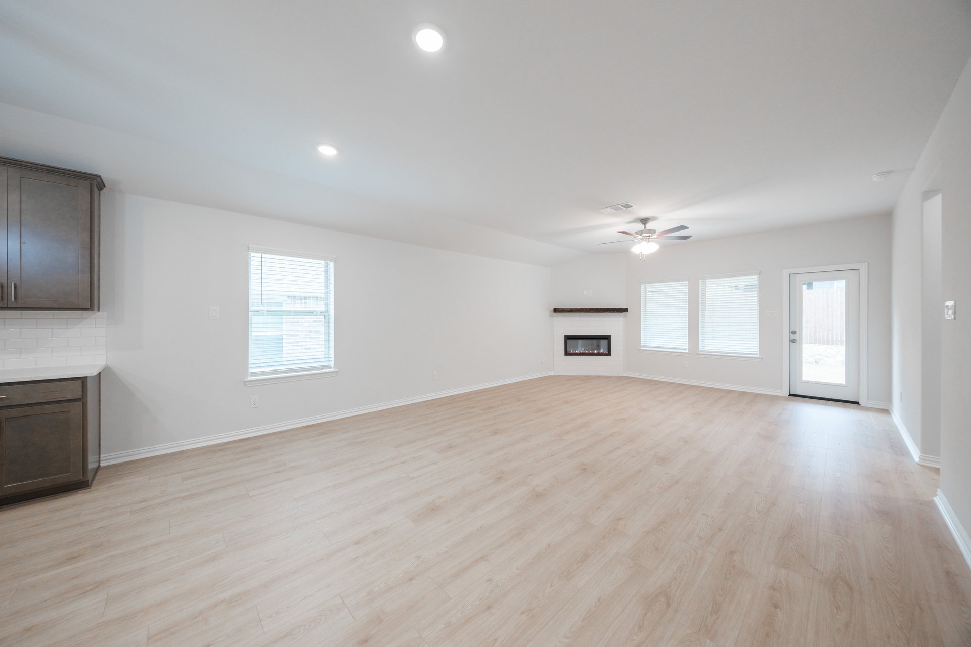 open great room with wood floors and fireplace