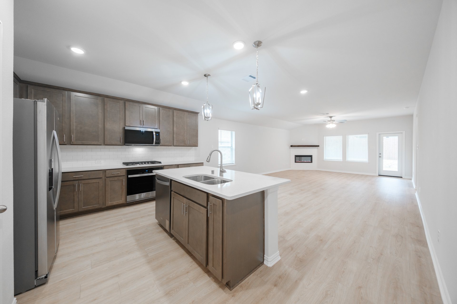 open kitchen with wood floors and island
