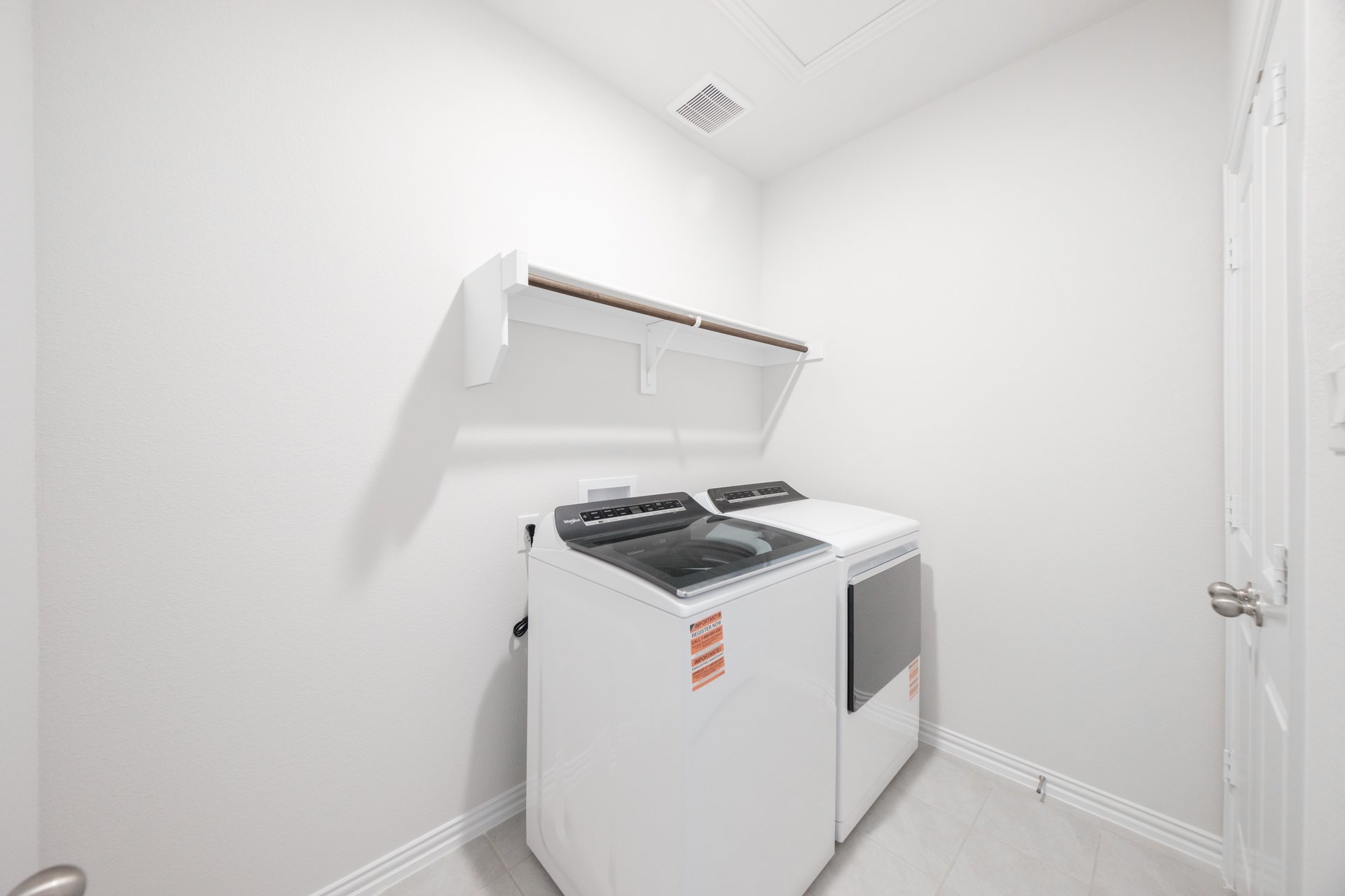 laundry room with tile floors, washer, and dryer
