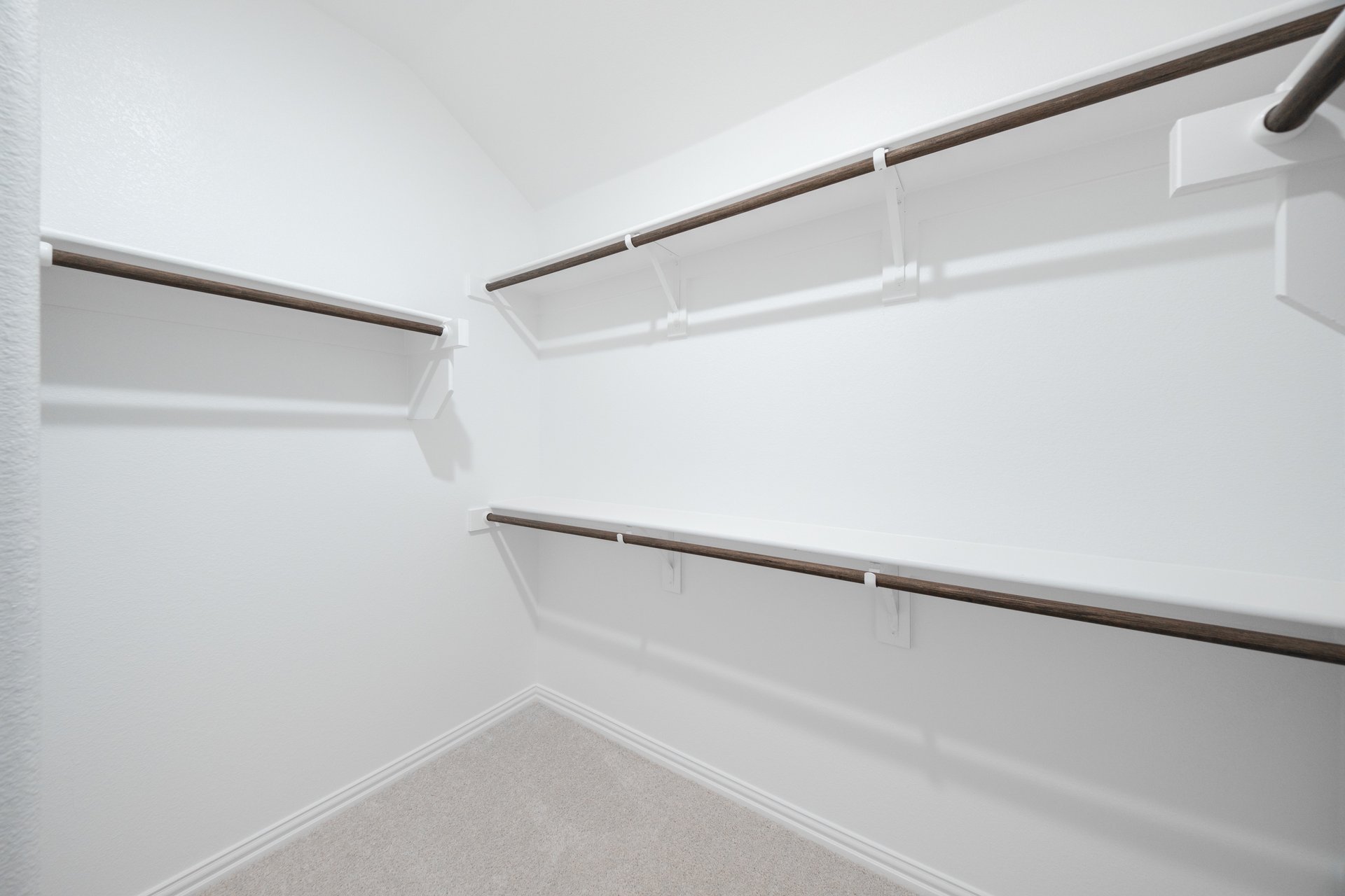 primary bedroom closet with carpet and white shelves