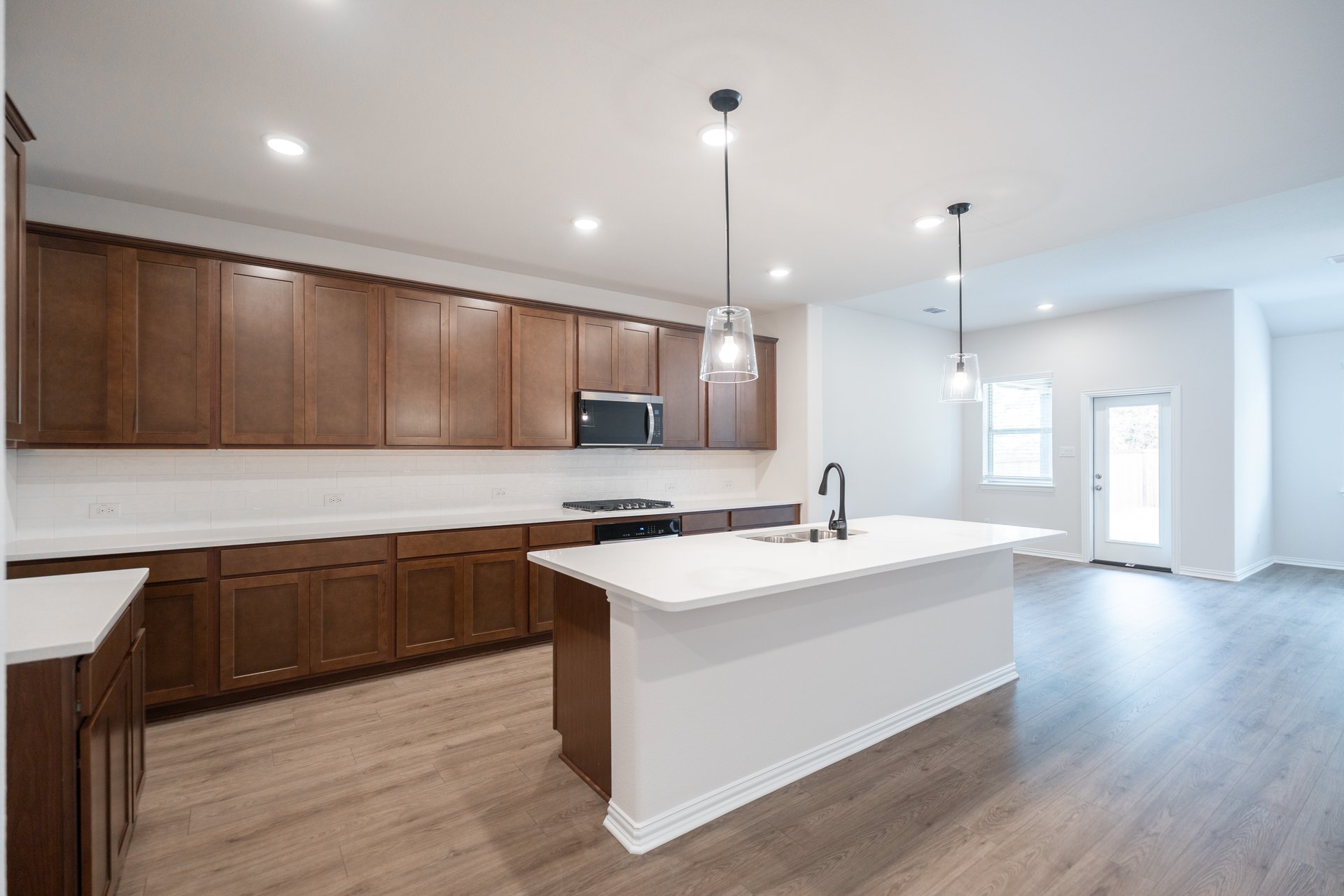 open kitchen with wood floors and island
