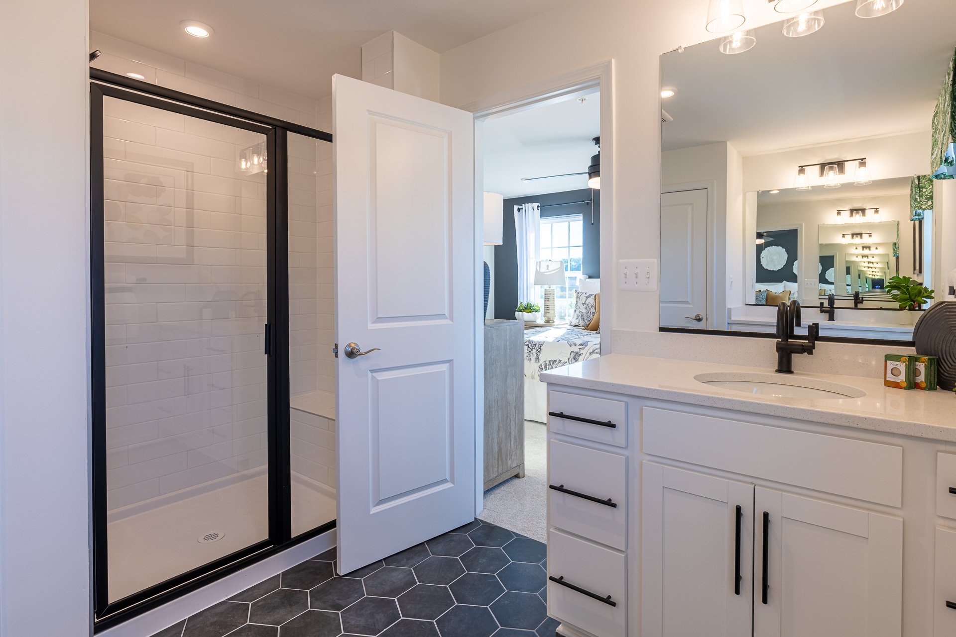 primary bath with a large shower with a seat