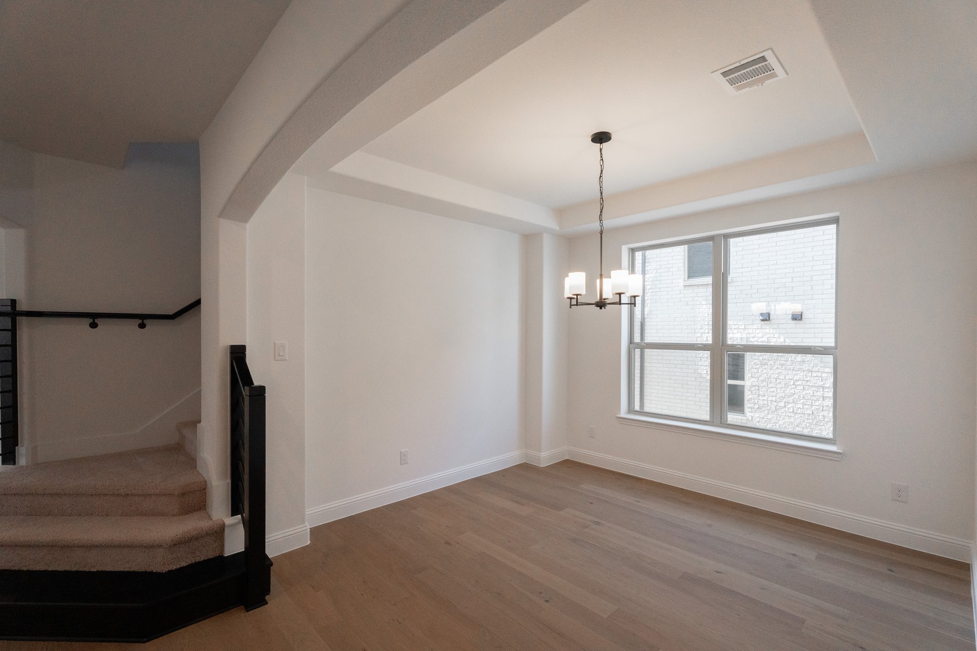 dining room with large window and chandelier