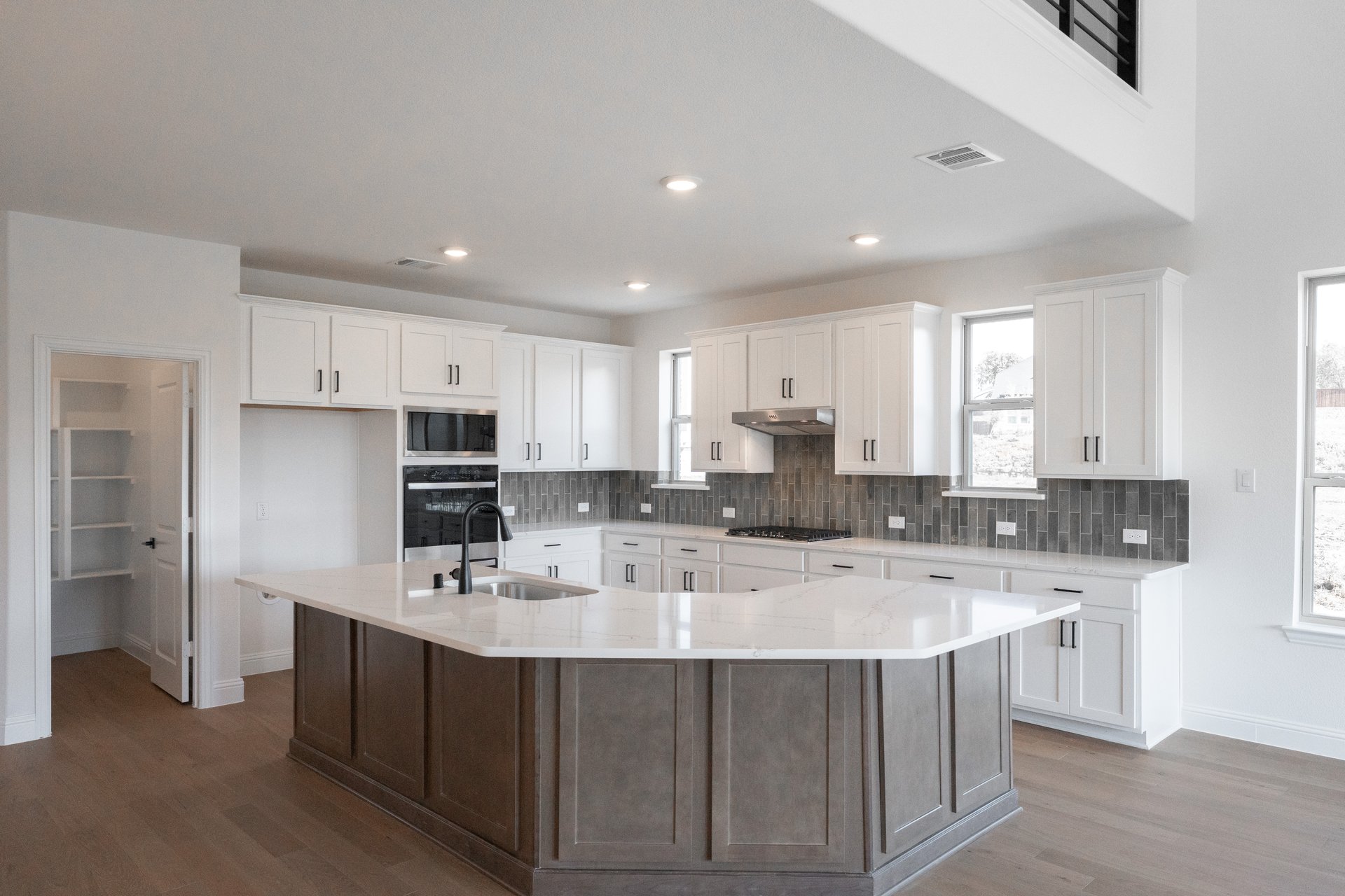 kitchen with large island and white cabinets