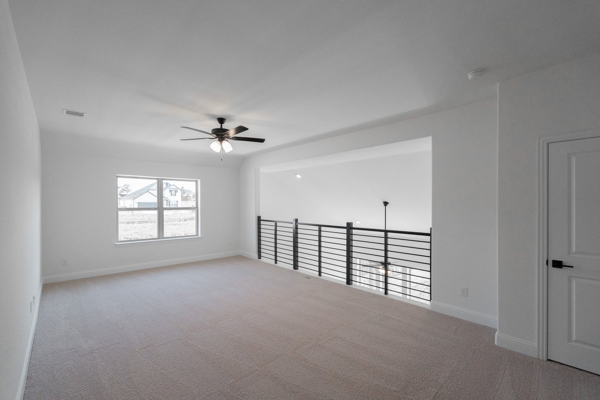 loft with carpet and large window