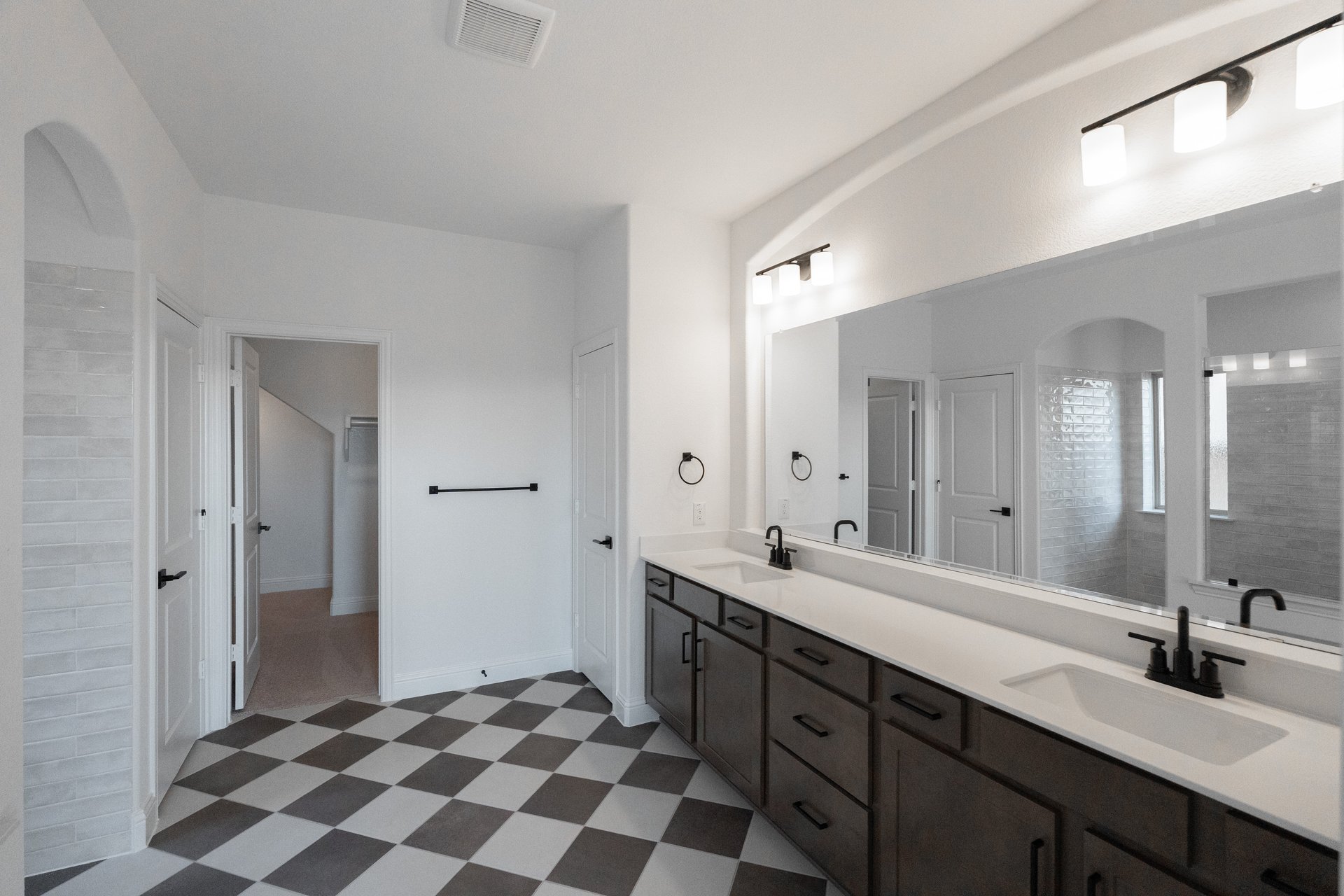bathroom with checker tile and white countertops