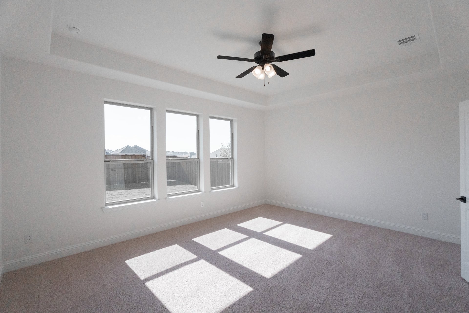bedroom with large windows and carpet