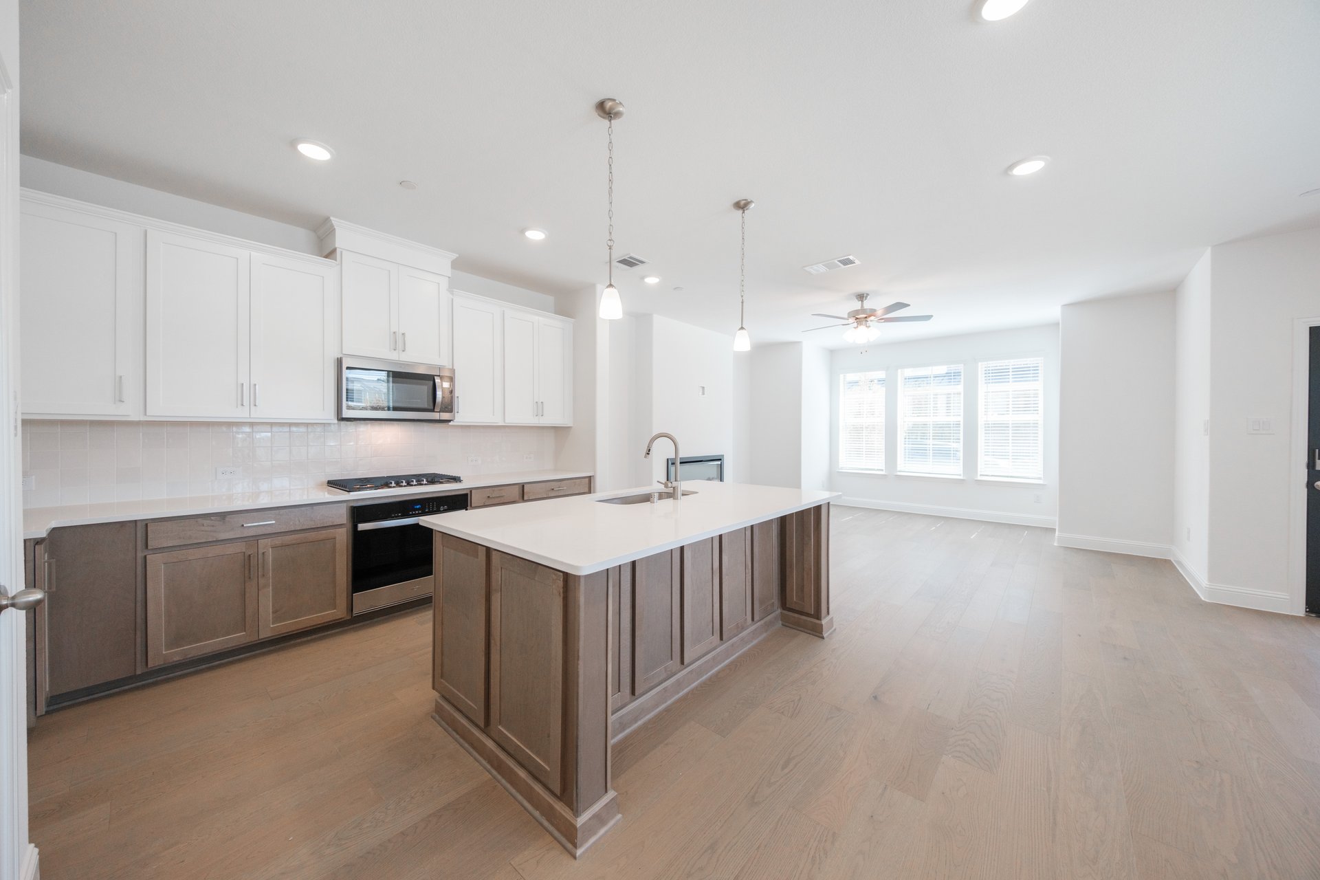 open kitchen with wood floors and island
