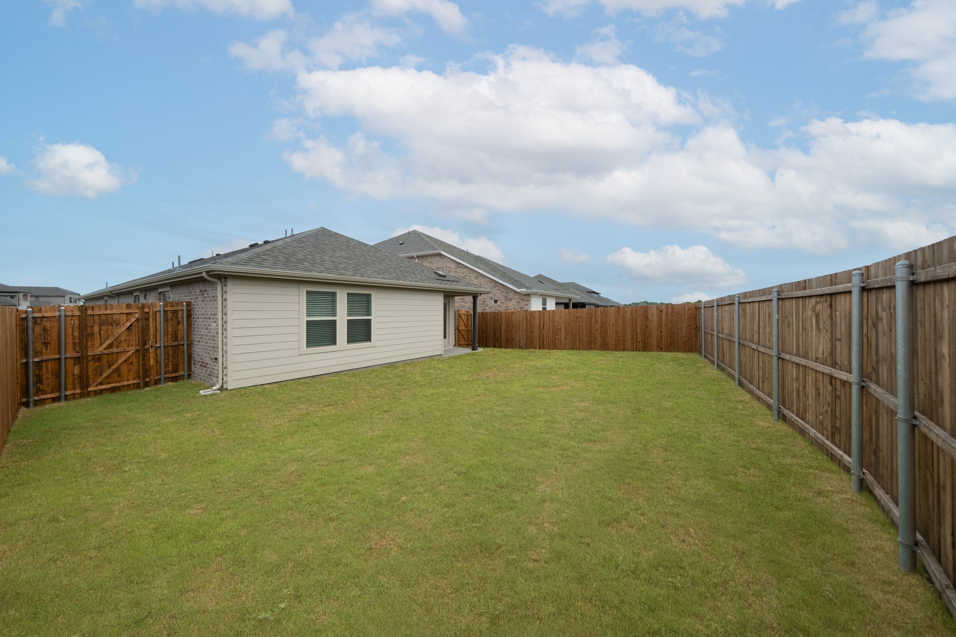 backyard with grass and covered patio