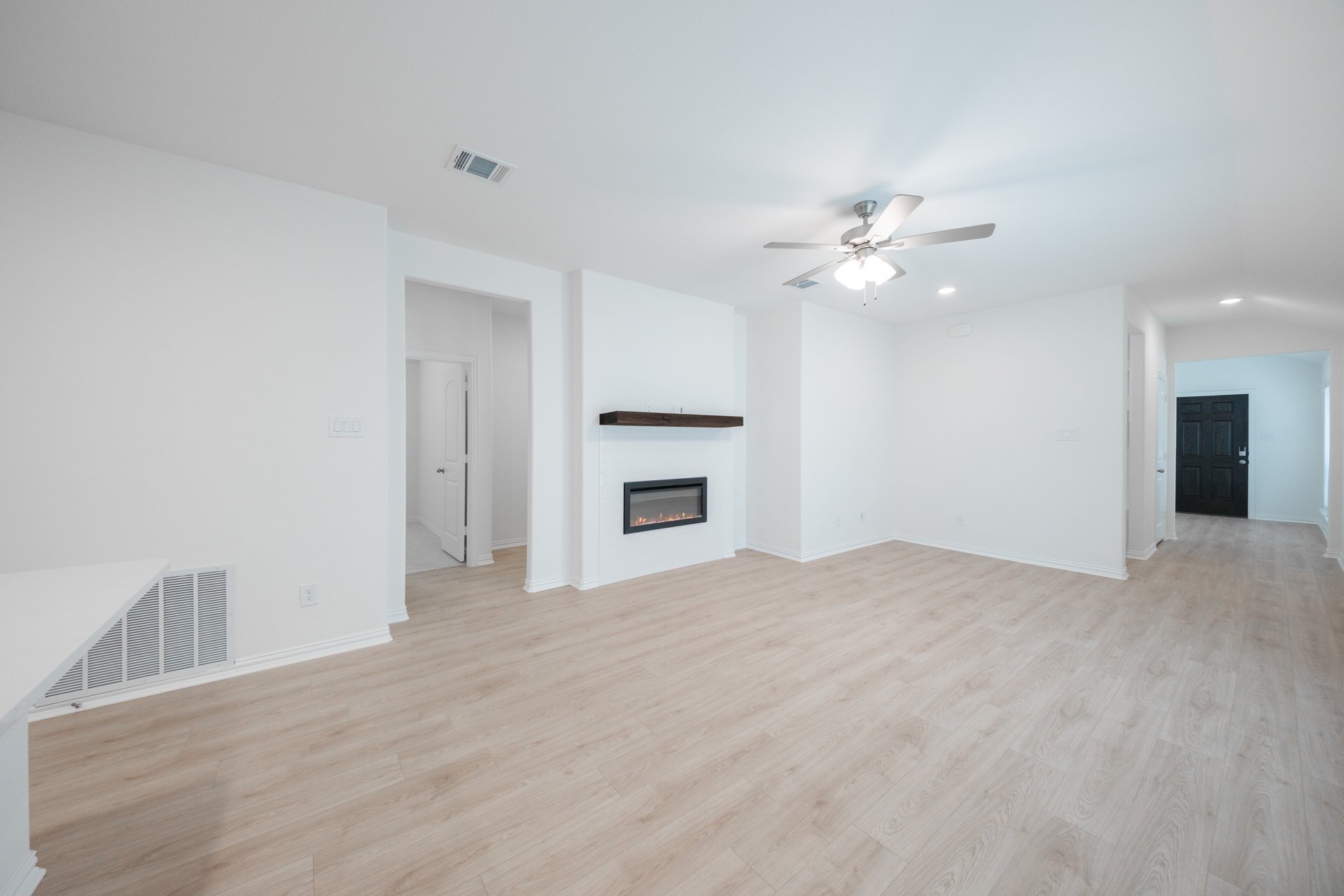open great room with wood floors and fireplace