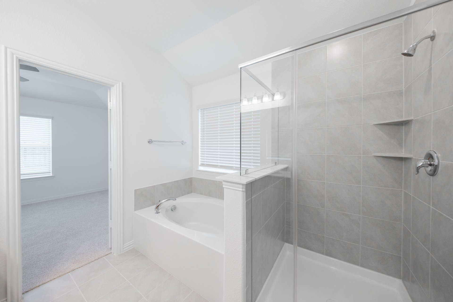 primary bathroom with soaking tub and walk-in shower
