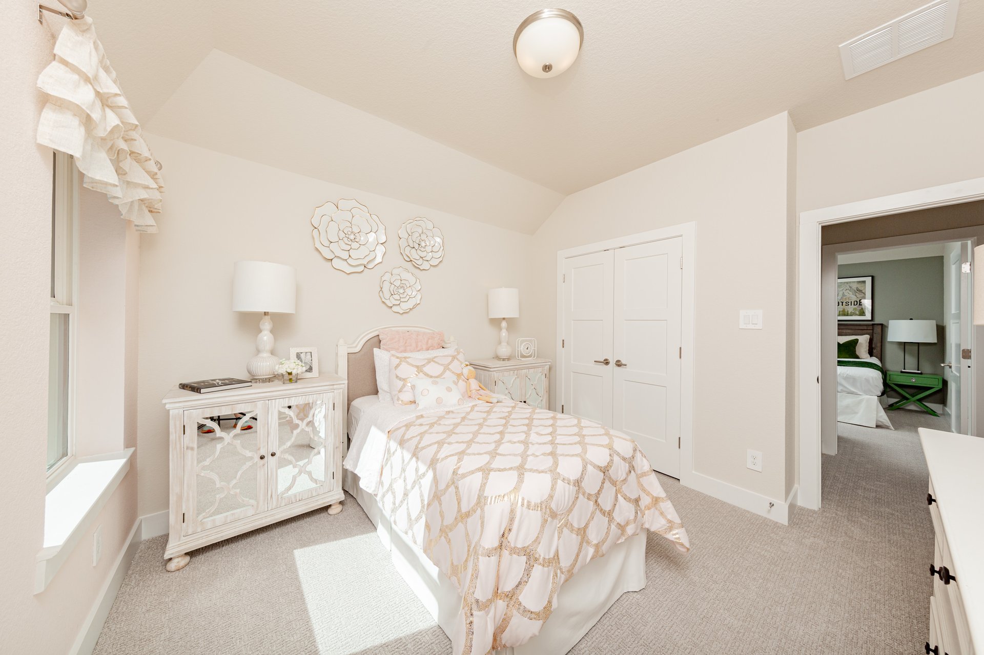 secondary bedroom with carpet and windows
