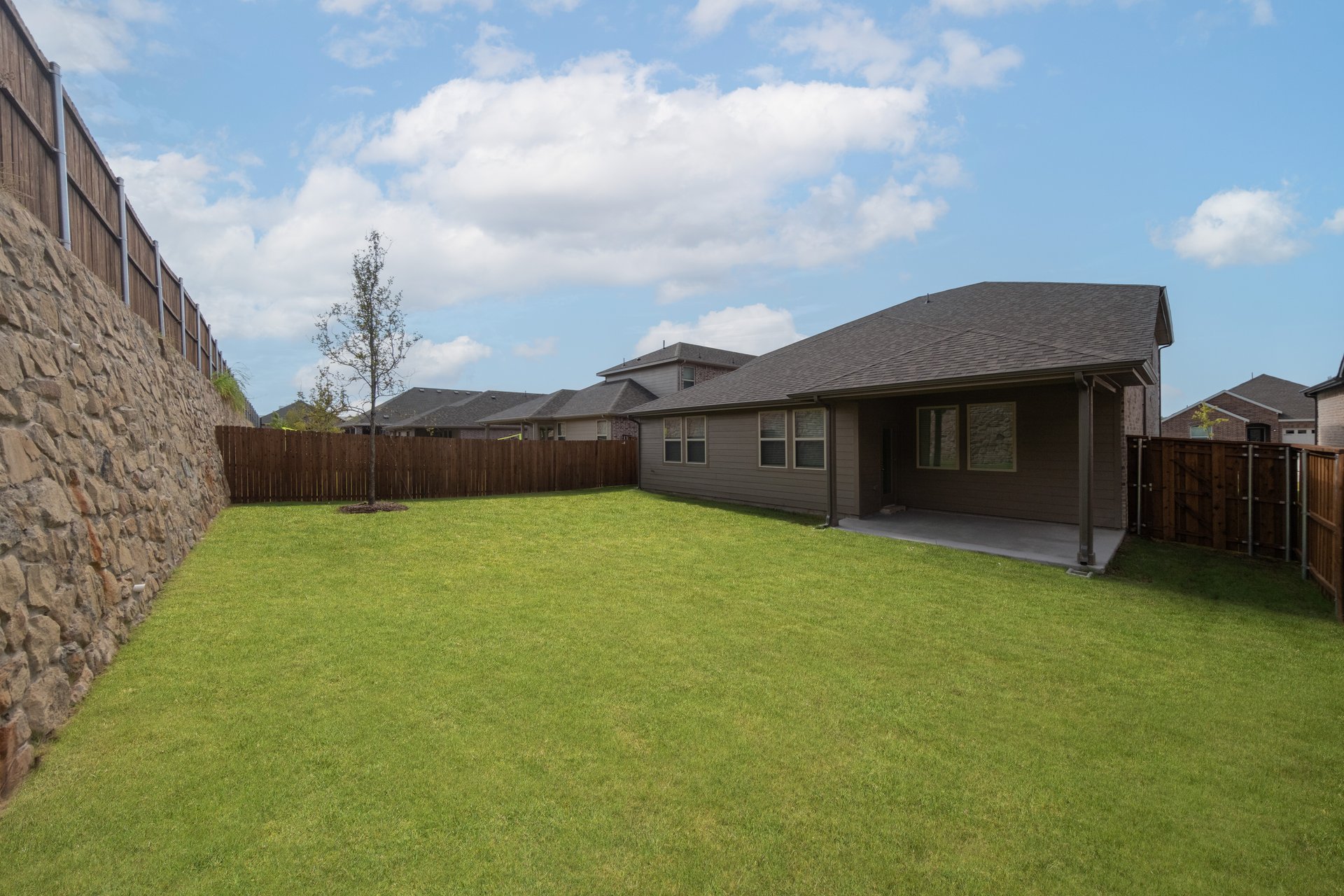 backyard with grass and covered patio