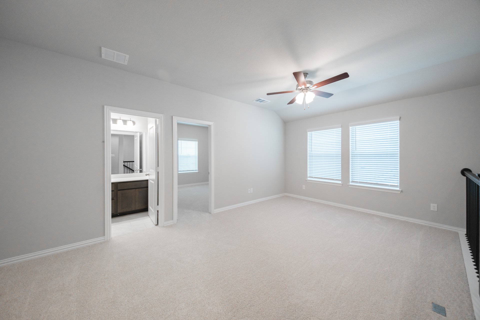 open loft with carpet, window, and ceiling fan