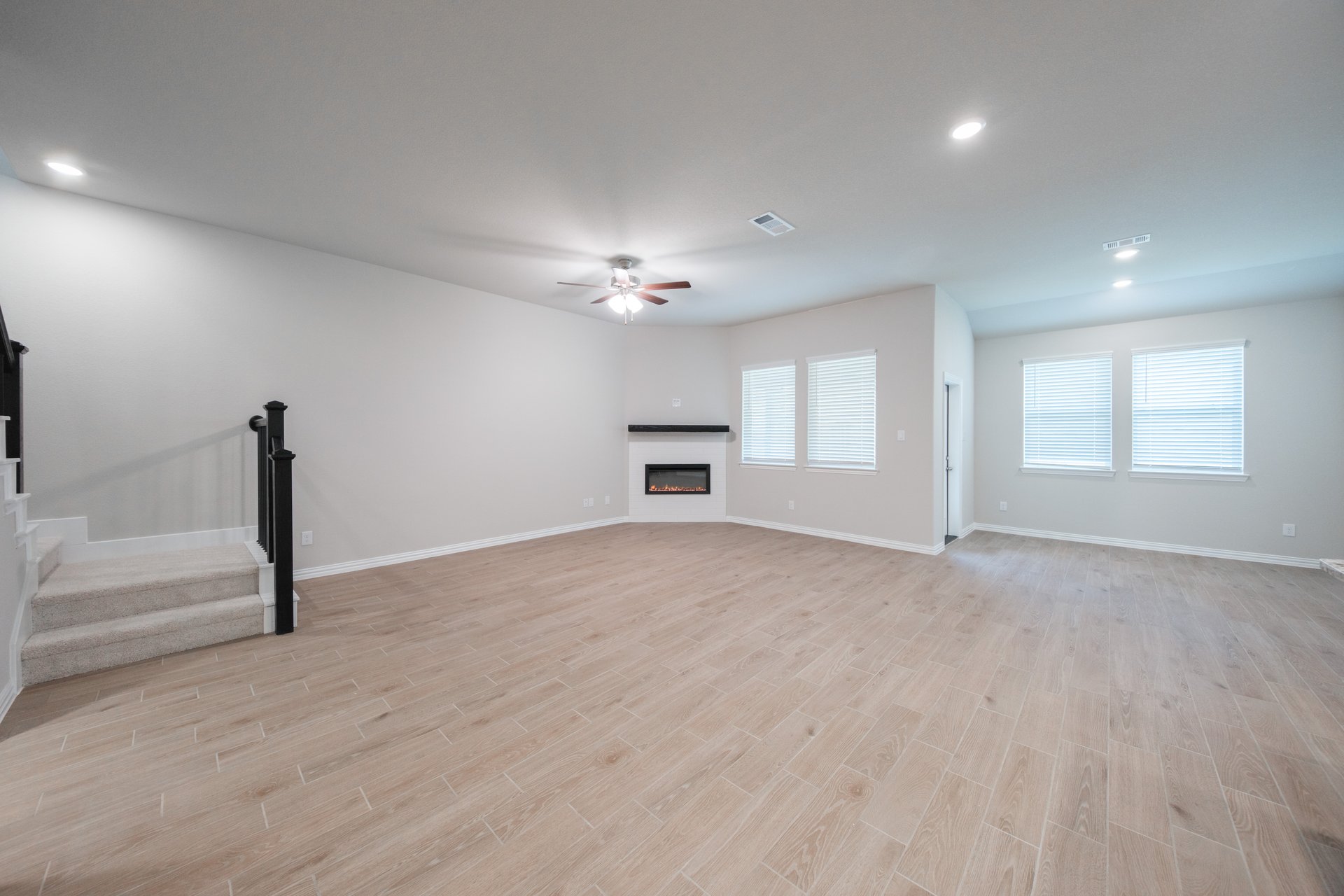 open great room with wood floors and fireplace