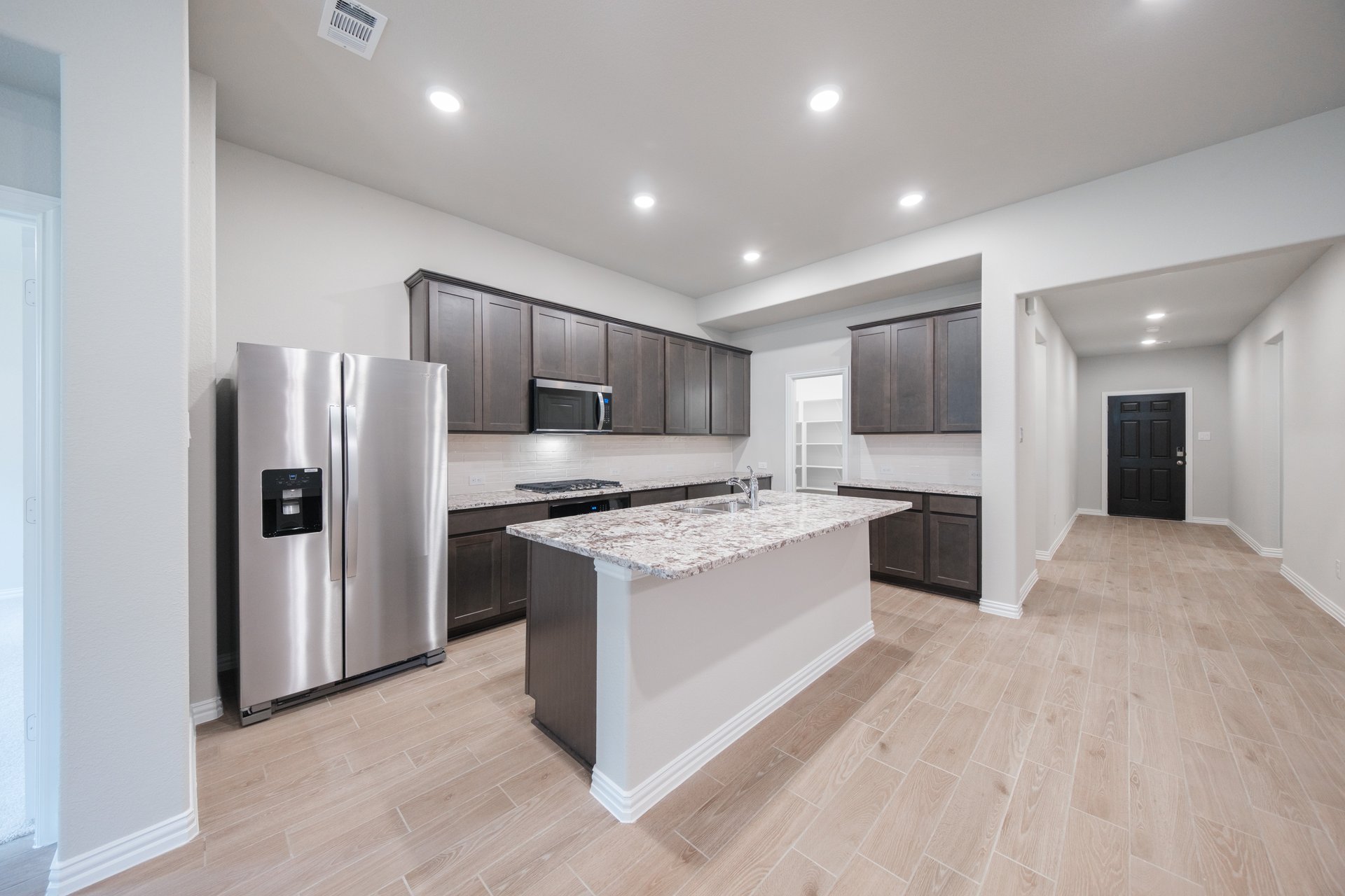 open kitchen with wood floors and island