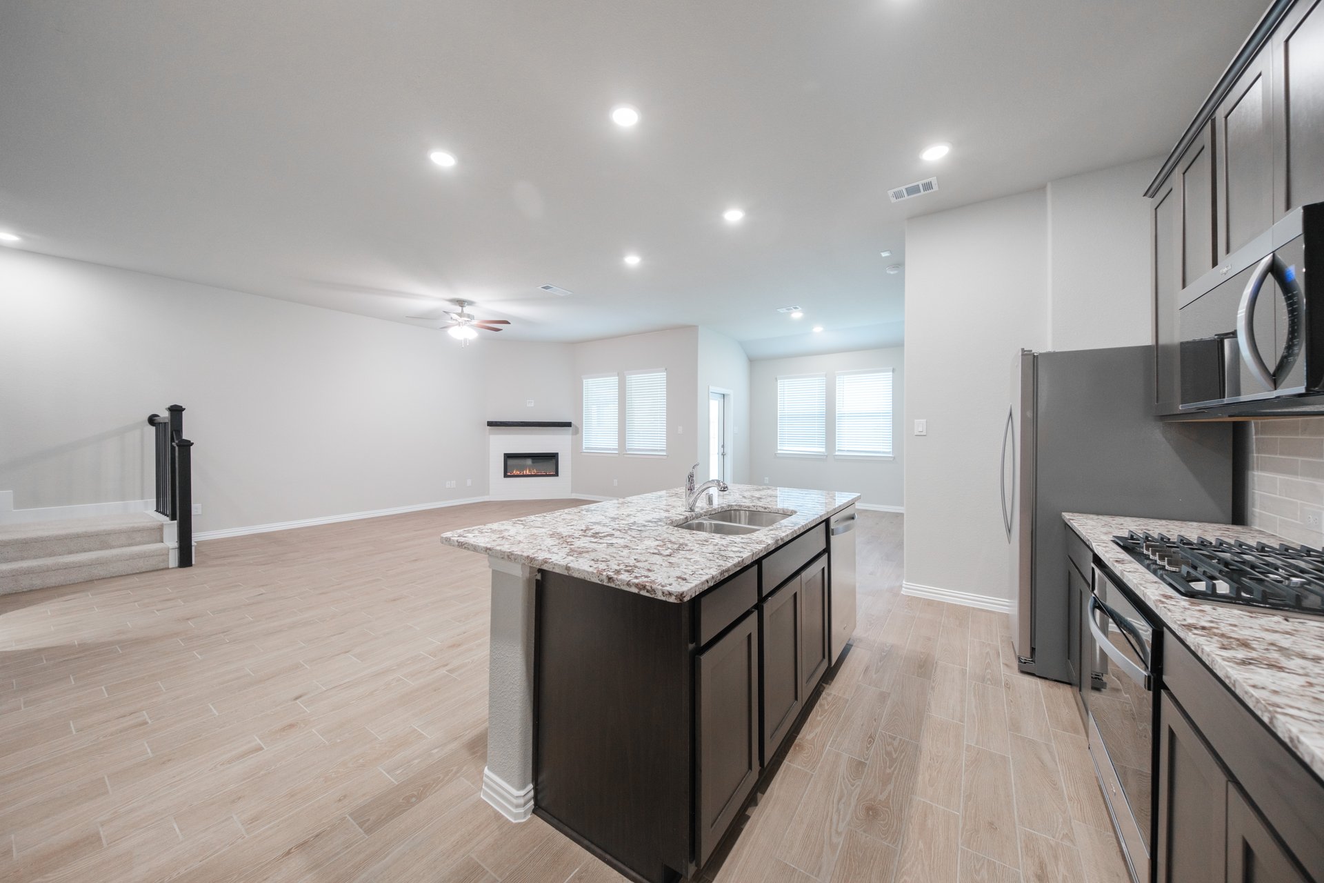 open kitchen with wood floors and island