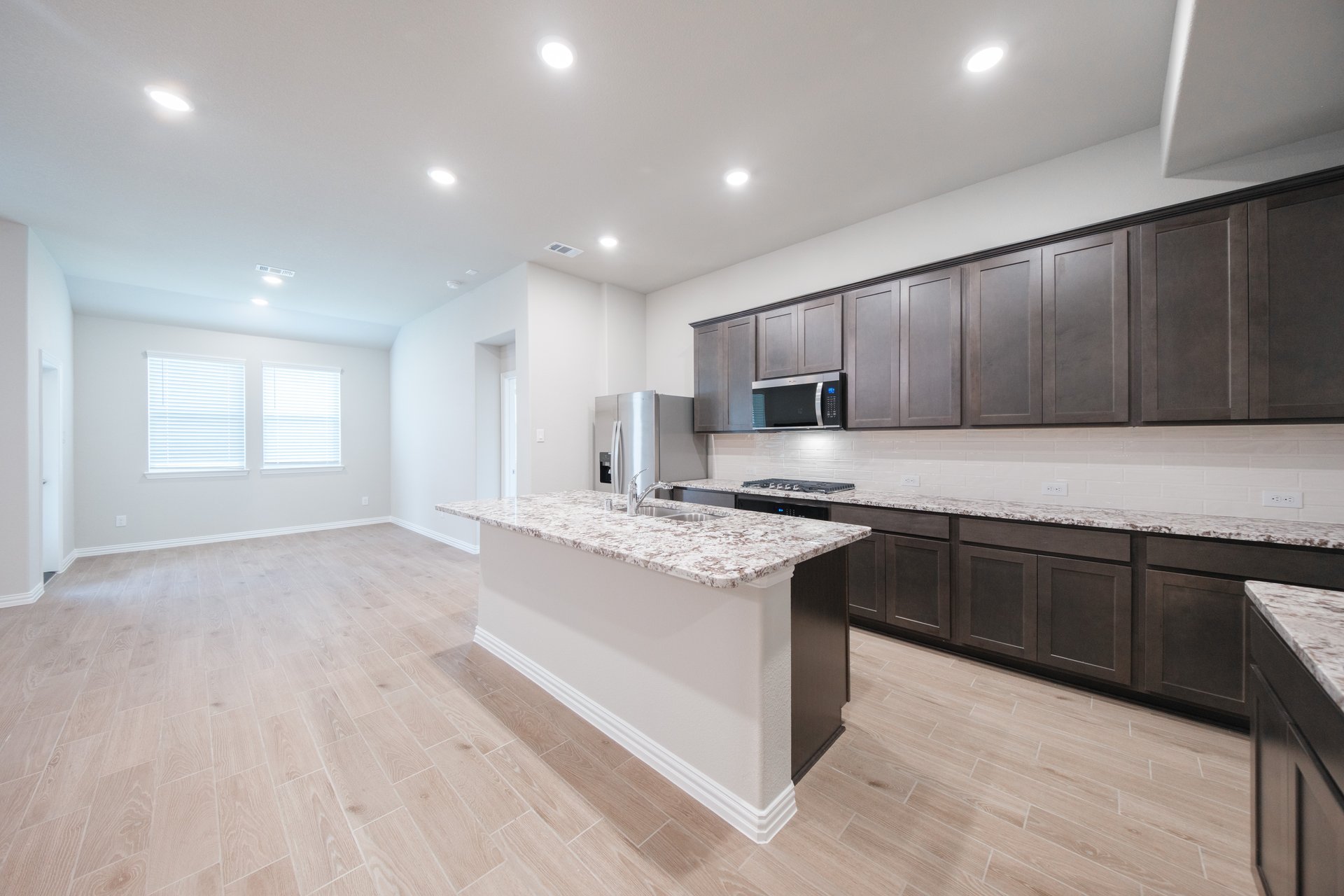 open kitchen with wood floors and island