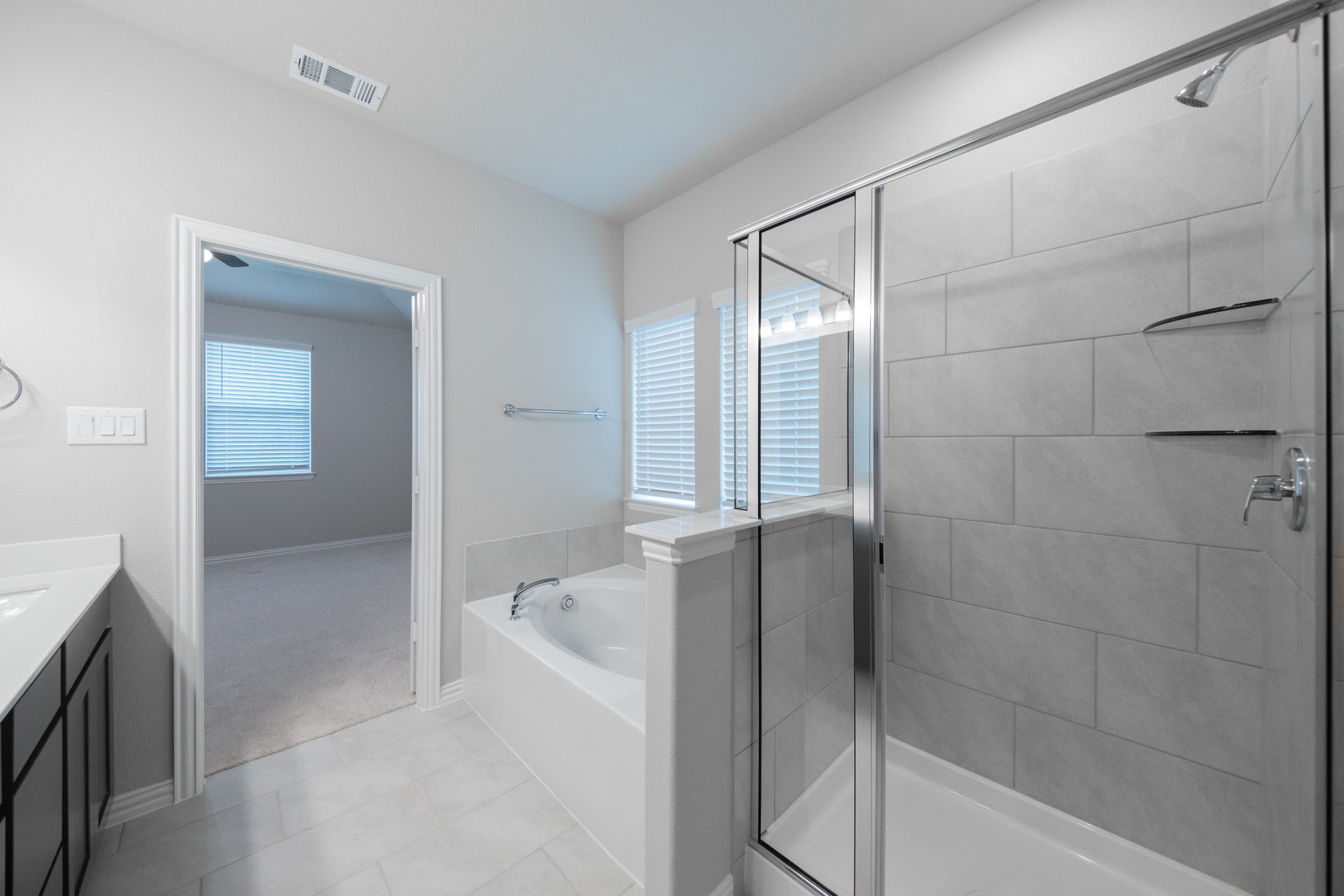 primary bathroom with soaking tub and walk-in shower