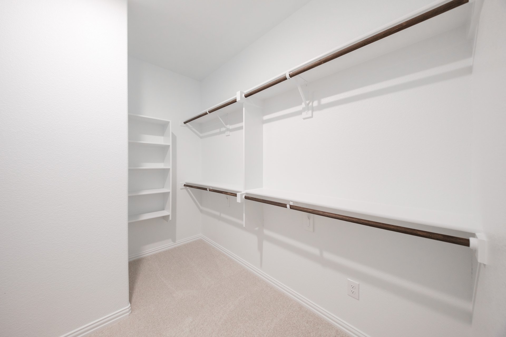 primary bedroom closet with carpet and white shelves