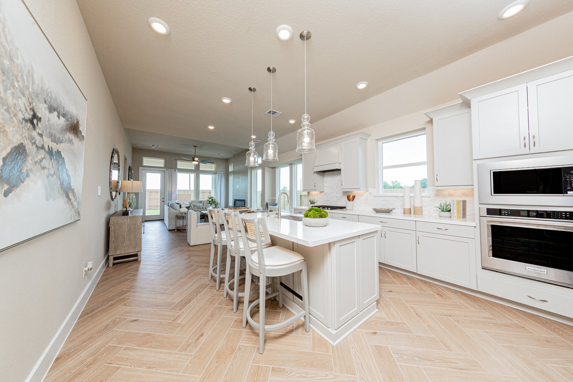kitchen with barstools and pendant lights