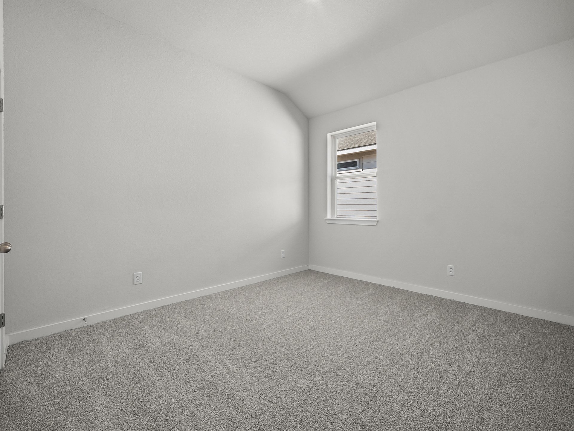bedroom with carpet, a window & a sloped ceiling